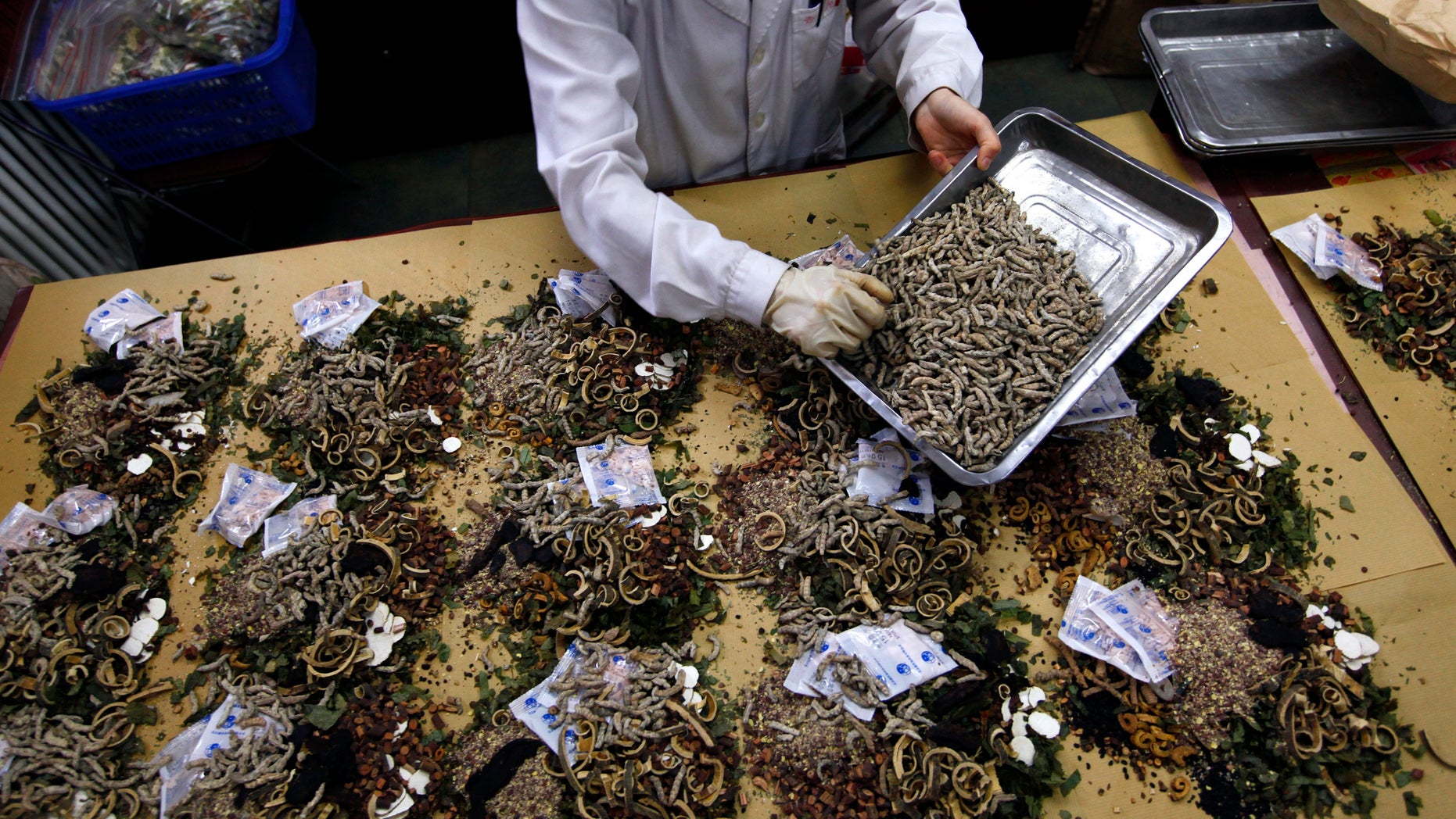 A worker prepares traditional Chinese herbal medicines at Beijing's Capital Medical University Traditional Chinese Medicine Hospital May 25, 2011. Cleveland Clinic in Ohio is now offering similar medications for some patients. (REUTERS/David Gray)