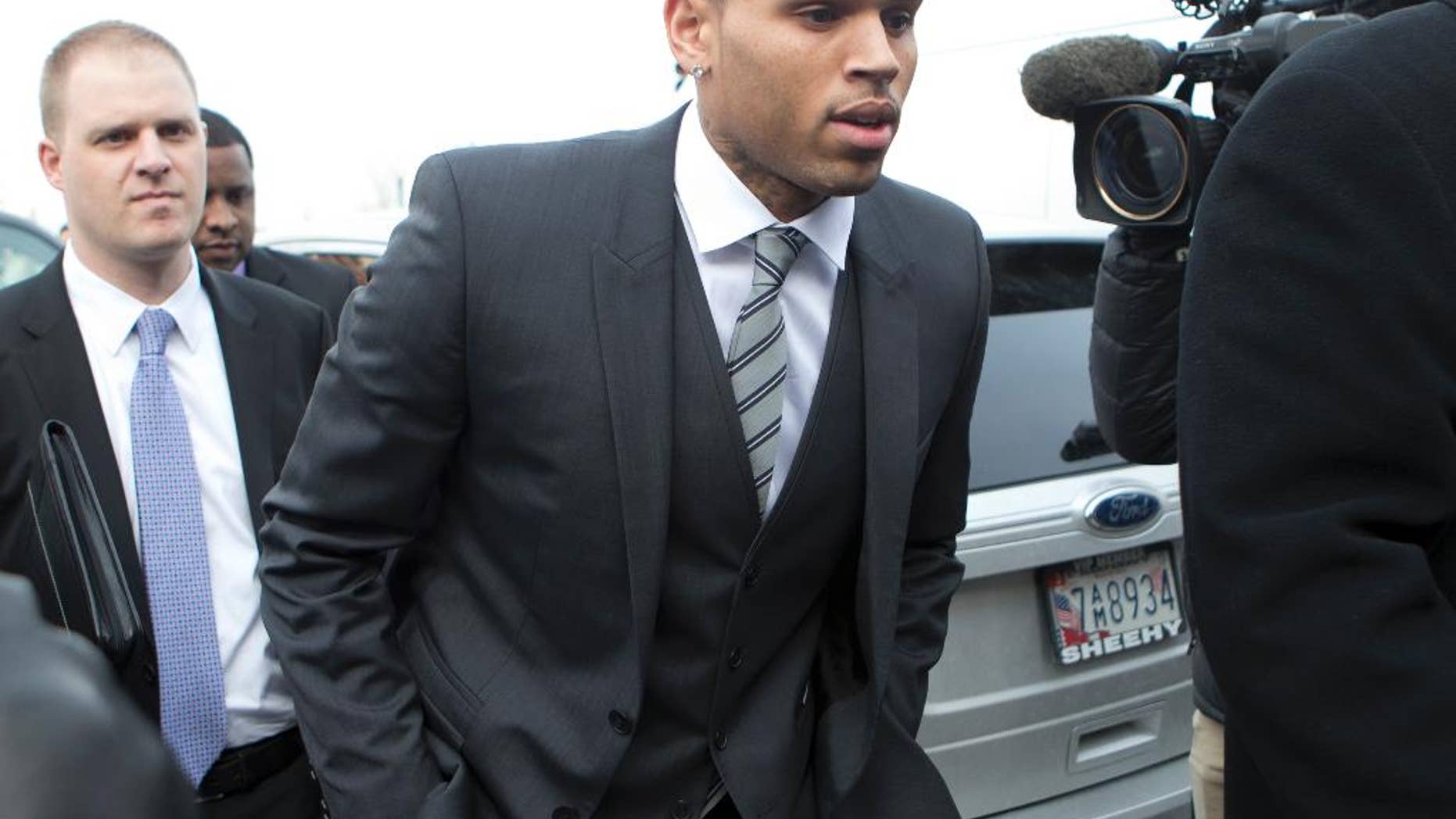 FILE - This Jan. 8, 2014 file photo shows singer Chris Brown arriving at the District of Columbia Superior Court in Washington. Lawyers for Brown are headed back to court in Washington, but the Grammy winner won't be there. Brown's trial on a misdemeanor assault charge is currently set for April 17. On Monday, his lawyers and a government prosecutor will be in court for a motions hearing. Brown's lawyers have asked a judge to dismiss the case, saying prosecutors misused the grand jury process to prepare for trial. They also want certain statements Brown made suppressed. (AP Photo/Manuel Balce Ceneta, File)