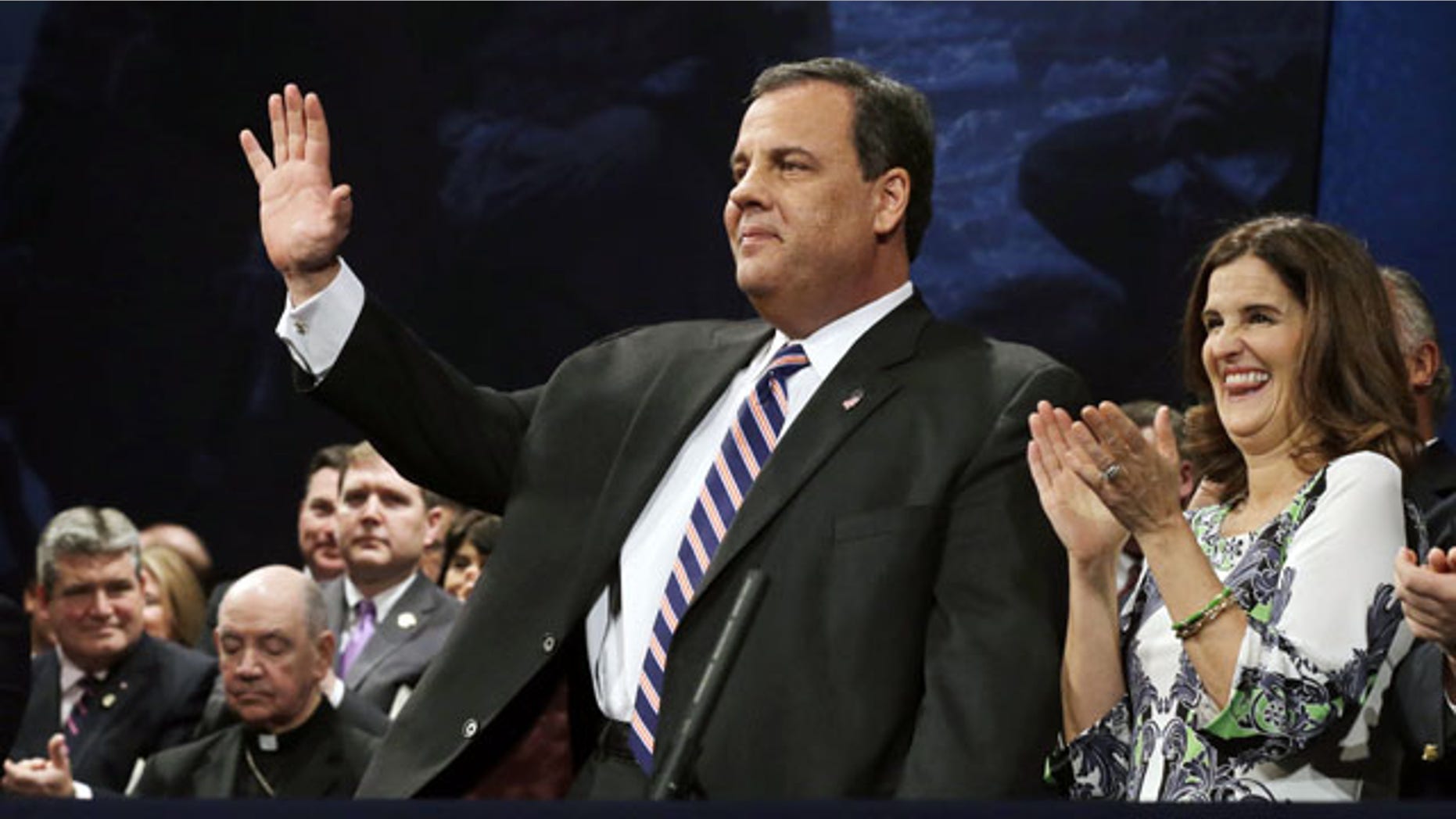 January 21, 2014: New Jersey Gov. Chris Christie waves as he stands with his wife Mary Pat Christie during a gathering for his swearing in for his second term in Trenton, N.J. (AP Photo)
