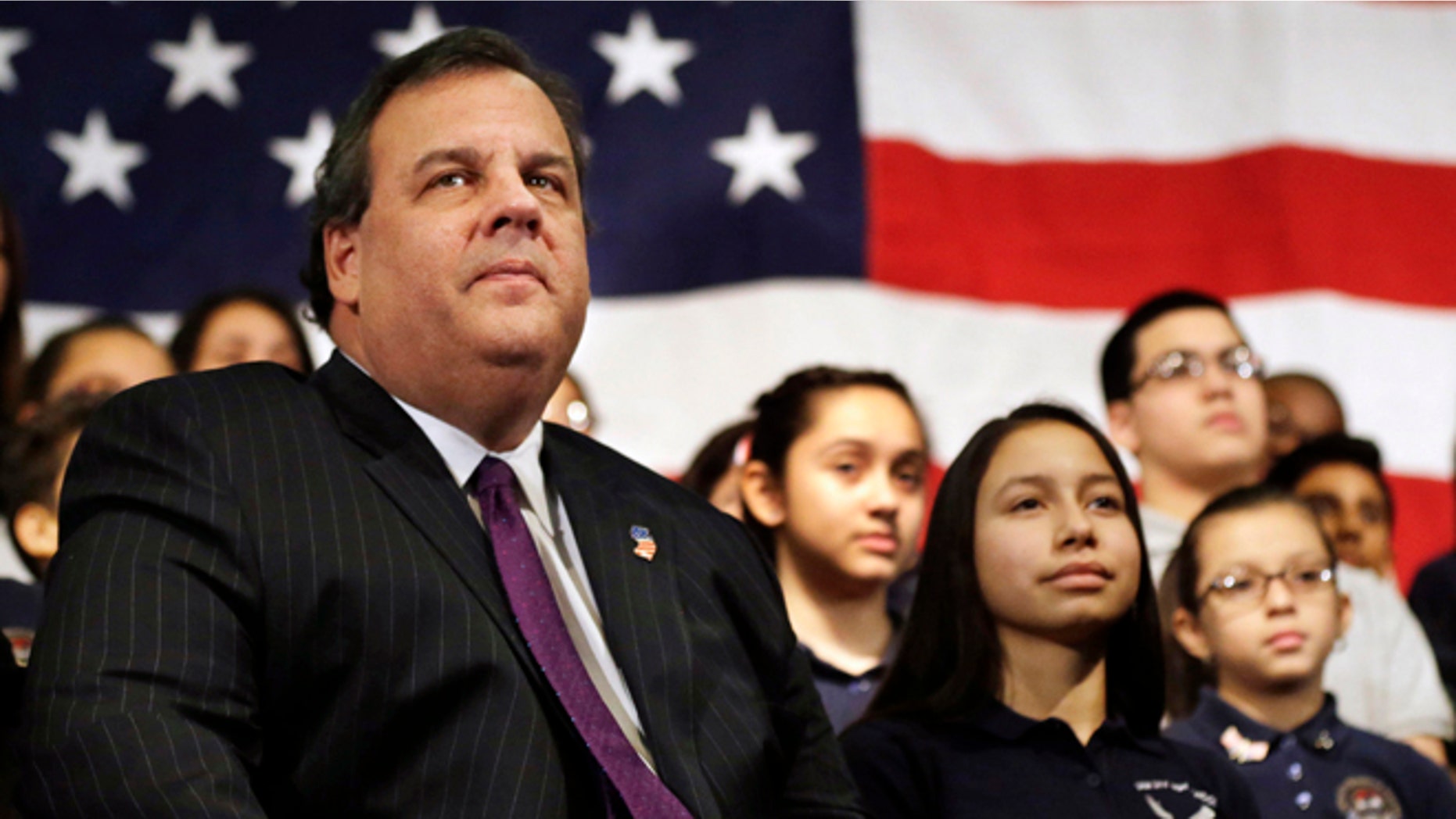 FILE - In this Jan. 7, 2014 file photo, New Jersey Gov. Chris Christie sits with students during a gathering at Colin Powell elementary school in heavily Hispanic Union City, N.J. after he ceremonially signed a bill that lowers tuition costs at public colleges for New Jersey students who lack lawful immigration status. A day after revelations that Christie's administration may have closed highway lanes to exact political retribution, the prospective Republican presidential candidate is faced with what may be the biggest test in his political career. (AP Photo/Mel Evans, File)