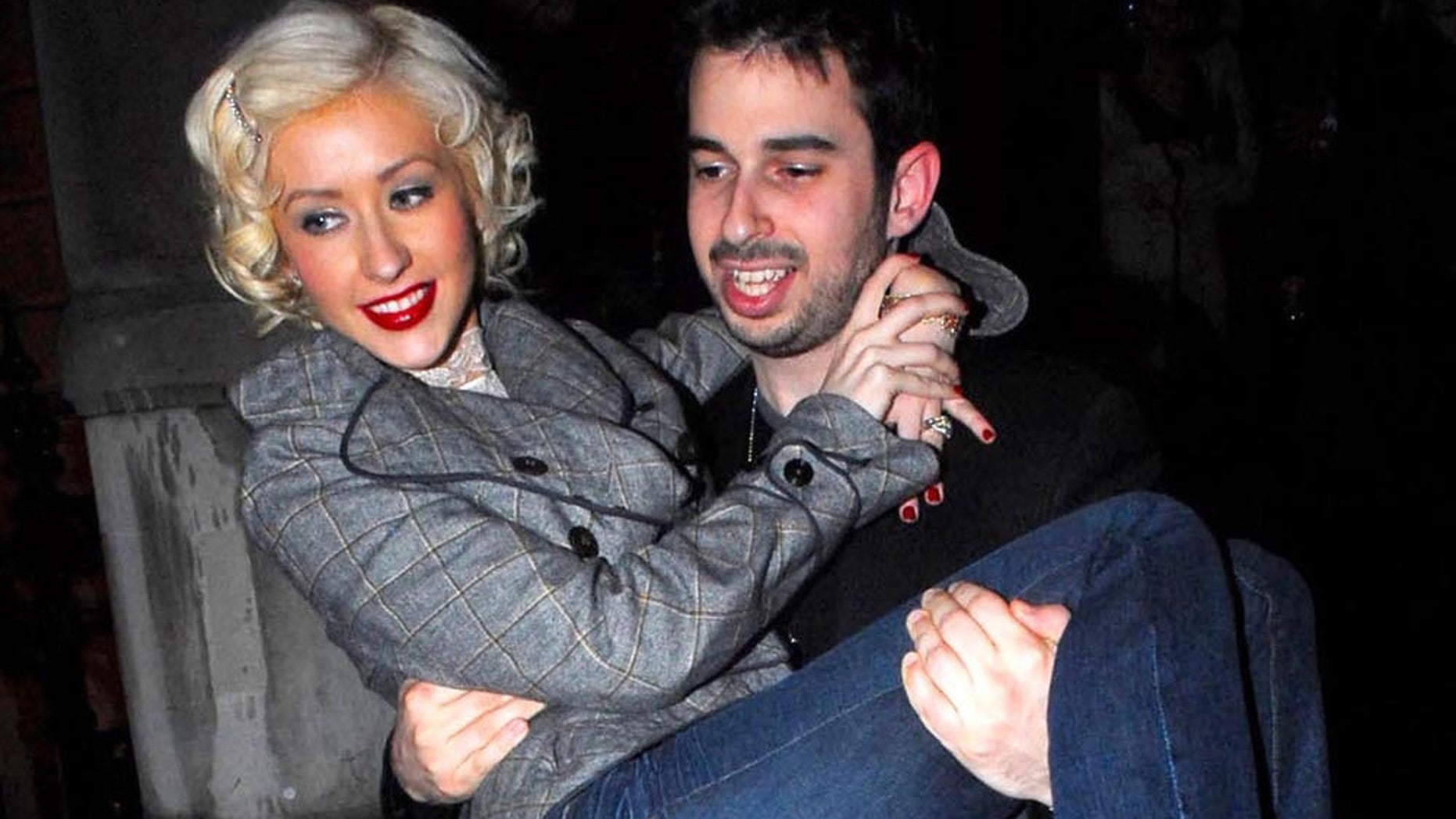 March 07, 2006: In happier days together pop star Christina Aguilera is seen here leavening her exclusive London hotel with hubby Jordan Bratman while visiting the UK for an album release.