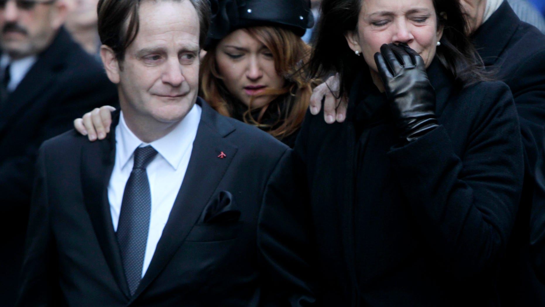 Jan. 5: Matthew Badger, left, and Madonna Badger, the parents of three children that were killed in a fire, react as their caskets are carried into a church during the funeral in New York.
