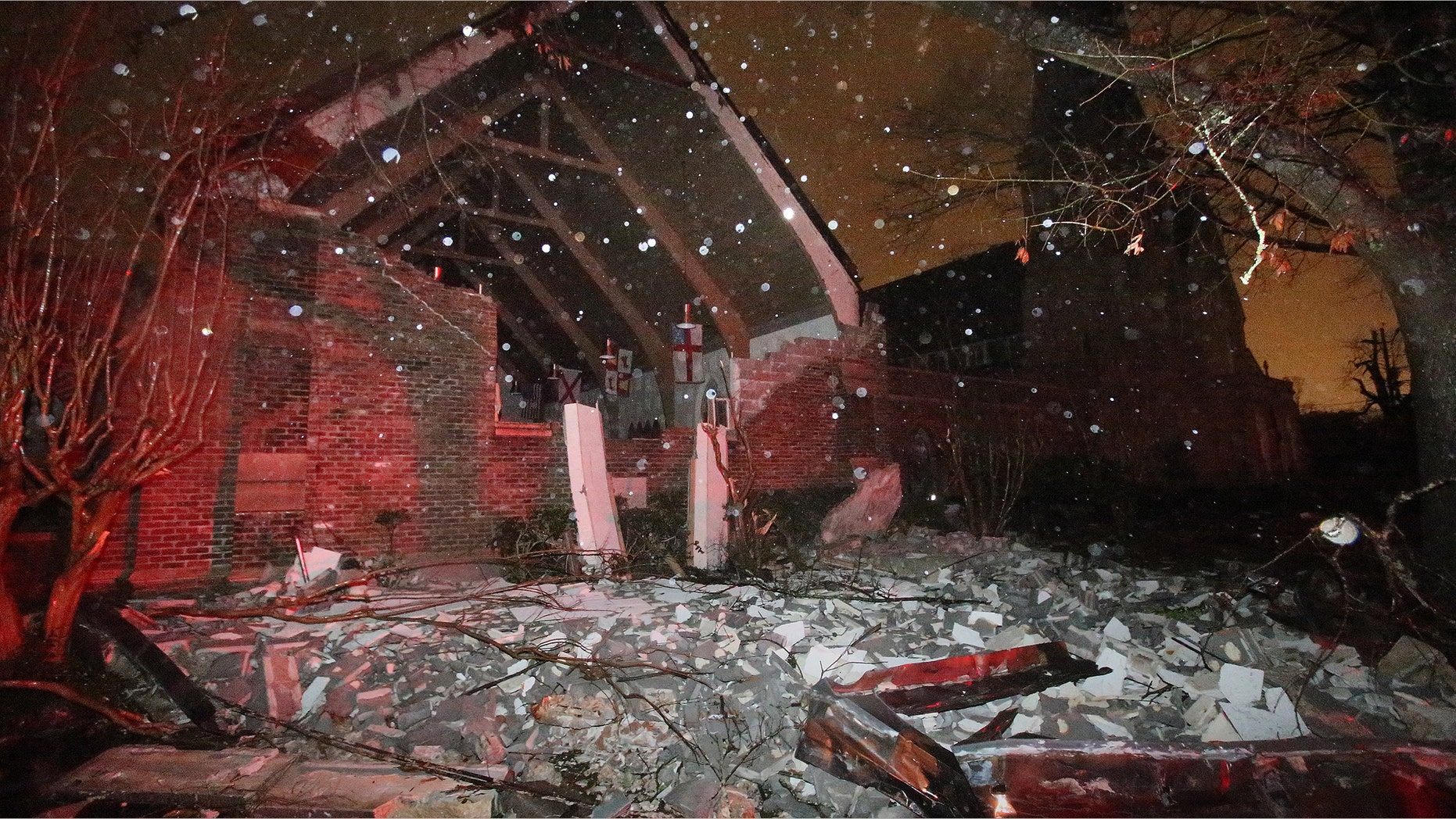 The front wall of the parish hall at Trinity Episcopal Church on Dauphin Street in Mobile, Ala. was torn off by a tornado on Christmas Day, Tuesday, Dec. 25, 2012 in Mobile, Ala. (AP Photo/AL.com, Bill Starling)