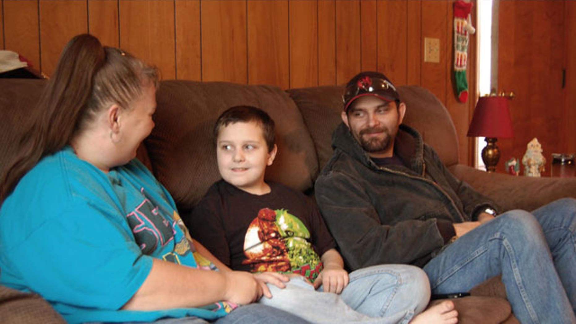 December 22, 2011: Kentucky mother Sandra Baker, left, sits with her son, Christopher, and husband, Scottie at Sandra’s home, in Harrodsburg, Ky.