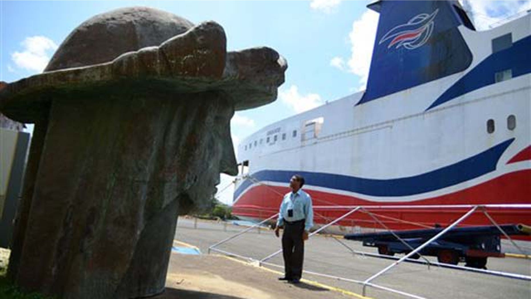 Sept. 2, 2011: Tony Jacobs, director of the port of Mayaguez, looks at the head of a statue of Christopher Columbus, one of many pieces strewn across the port storage area in Mayaguez, Puerto Rico.