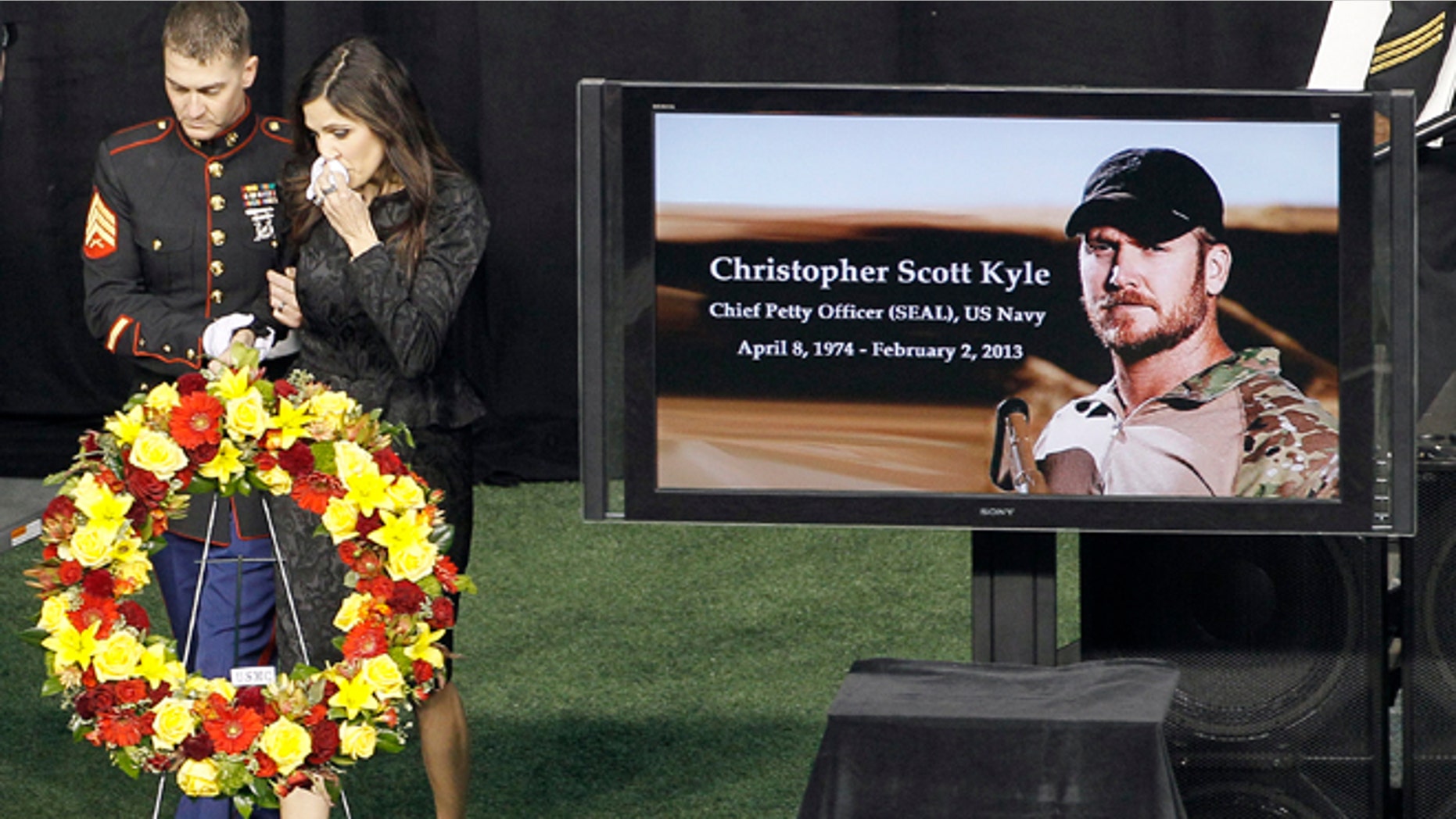 Feb. 11, 2013: In this file photo, Christopher Kyle's wife, Taya, is escorted to her seat after memorializing her husband in Arlington, Texas. Former Minnesota Gov. Jesse Ventura sued Chris Kyle, the author of the best-selling book American Sniper, for defamation in 2012 after Kyle claimed in his book that he punched Ventura at a California bar. Ventura says the incident never happened, and hes suing for damages. Kyle, of Texas, was killed last year on a gun range while the lawsuit was pending.
