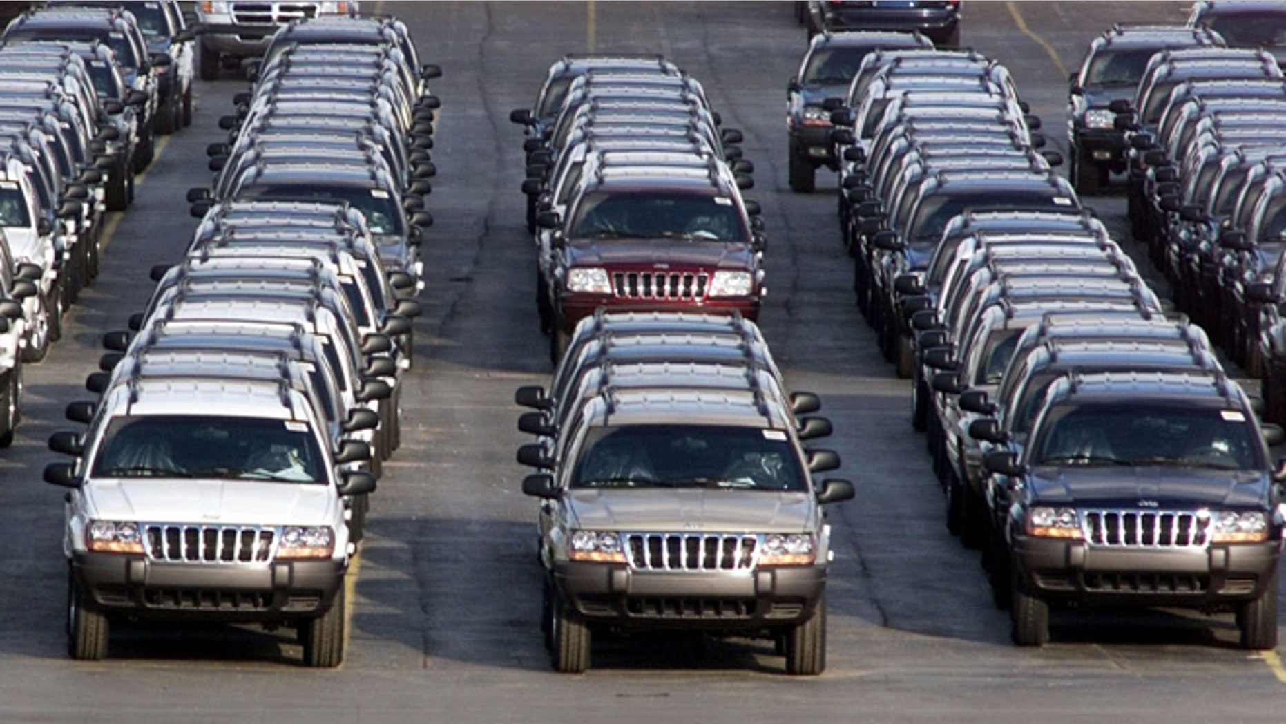 FILE - In this file photo taken Fed. 2, 2001, rows of 2001 Jeep Grand Cherokees are lined up outside the Jefferson North Assembly Plant in Detroit. (AP Photo/Carlos Osorio, File)