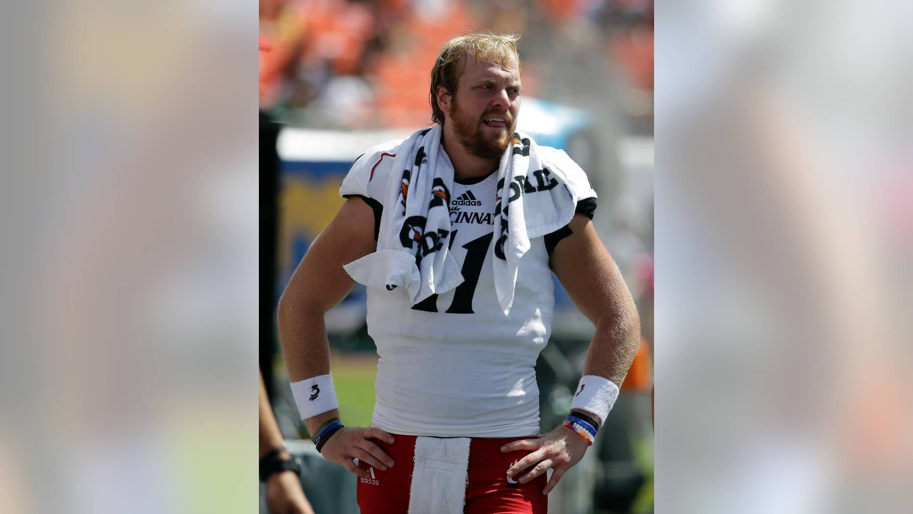 Cincinnati quarterback Gunner Kiel stands on the sideline in the first half of an NCAA college football game against Miami, Saturday, Oct. 11, 2014, in Miami Gardens, Fla. Miami defeated Cincinnati 55-34. (AP Photo/Lynne Sladky)