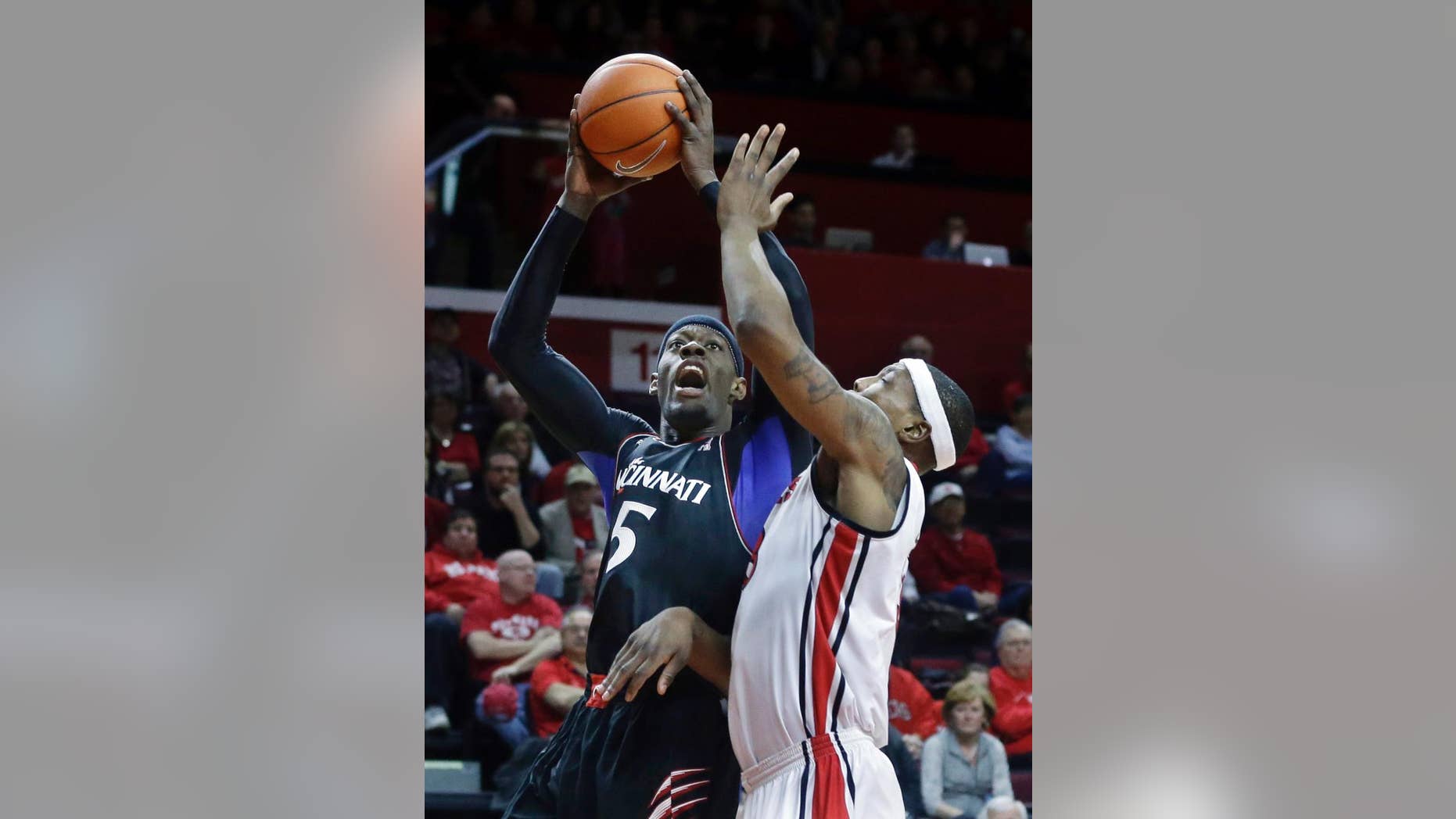 Cincinnati forward Justin Jackson (5) takes a shot past Rutgers forward Wally Judge (33) during the first half of an NCAA college basketball game Saturday, March 8, 2014, in Piscataway, N.J. (AP Photo/Mel Evans)