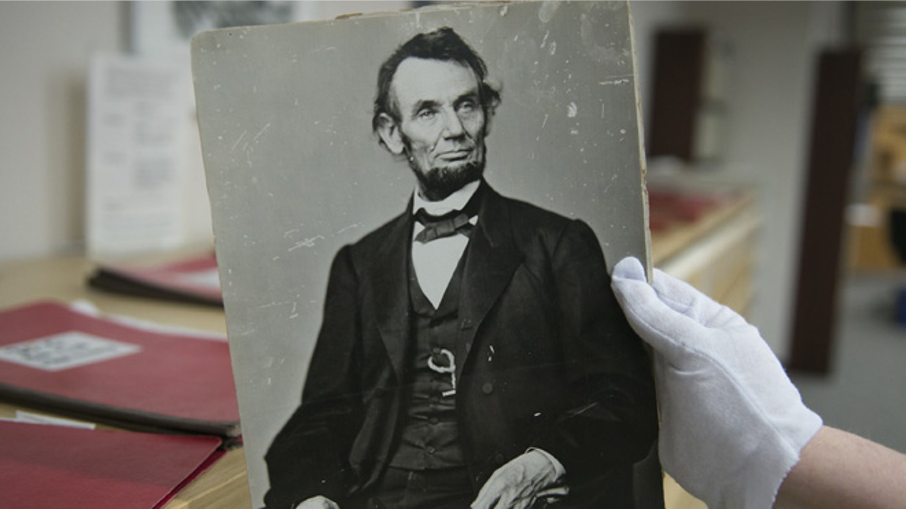 April 6, 2015: Karen Needles holds up a photograph of President Abraham Lincoln at the National Archives in College Park, Md.