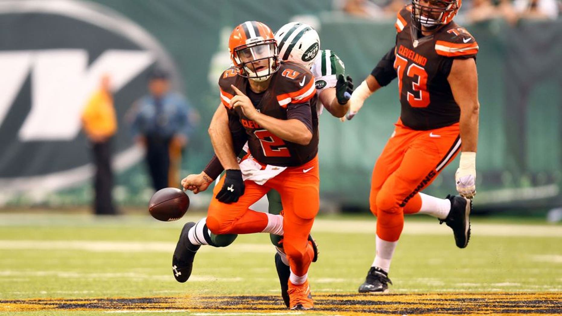Sep 13, 2015; East Rutherford, NJ, USA; Cleveland Browns quarterback Johnny Manziel (2) fumbles the ball after getting sacked by New York Jets linebacker Trevor Reilly (57) during the second half at MetLife Stadium. Mandatory Credit: Danny Wild-USA TODAY Sports