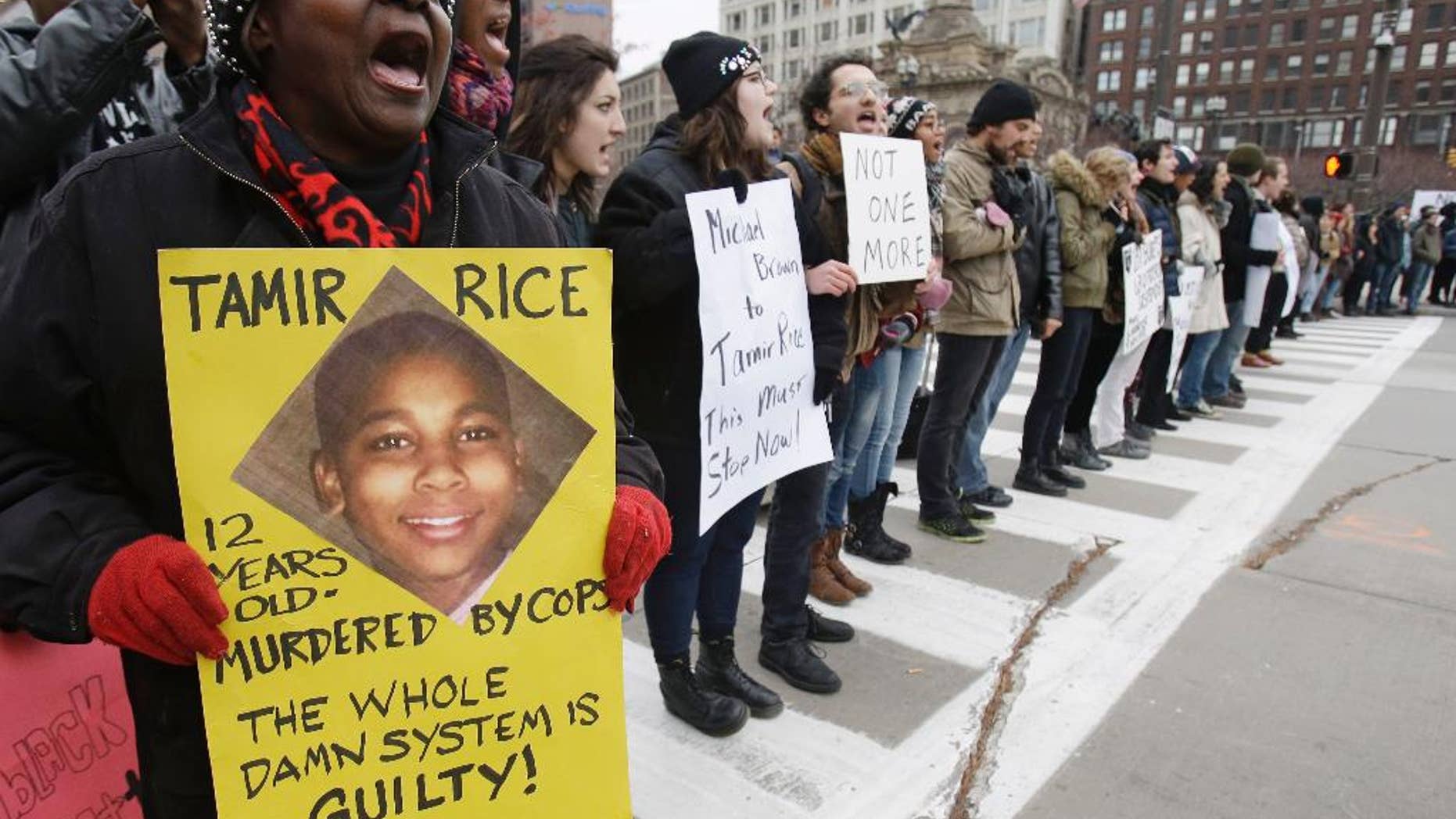 FILE- In this Nov. 25, 2014, file photo, demonstrators block Public Square Tuesday, Nov. 25, 2014, in Cleveland, during a protest over the police shooting of 12-year-old Tamir Rice. Cleveland’s politicians and community leaders are now working to make sure protests remain peaceful as the city awaits a verdict in the trial of a white officer in the deaths of the two unarmed people and a decision on whether charges will be filed in Rice's death. (AP Photo/Tony Dejak, File)