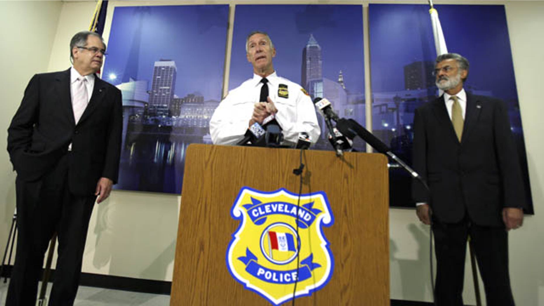 October 15, 2013: Cleveland Police Chief Michael McGrath, center, announces the results of disciplinary hearings for officers involved in a deadly chase. (AP Photo)