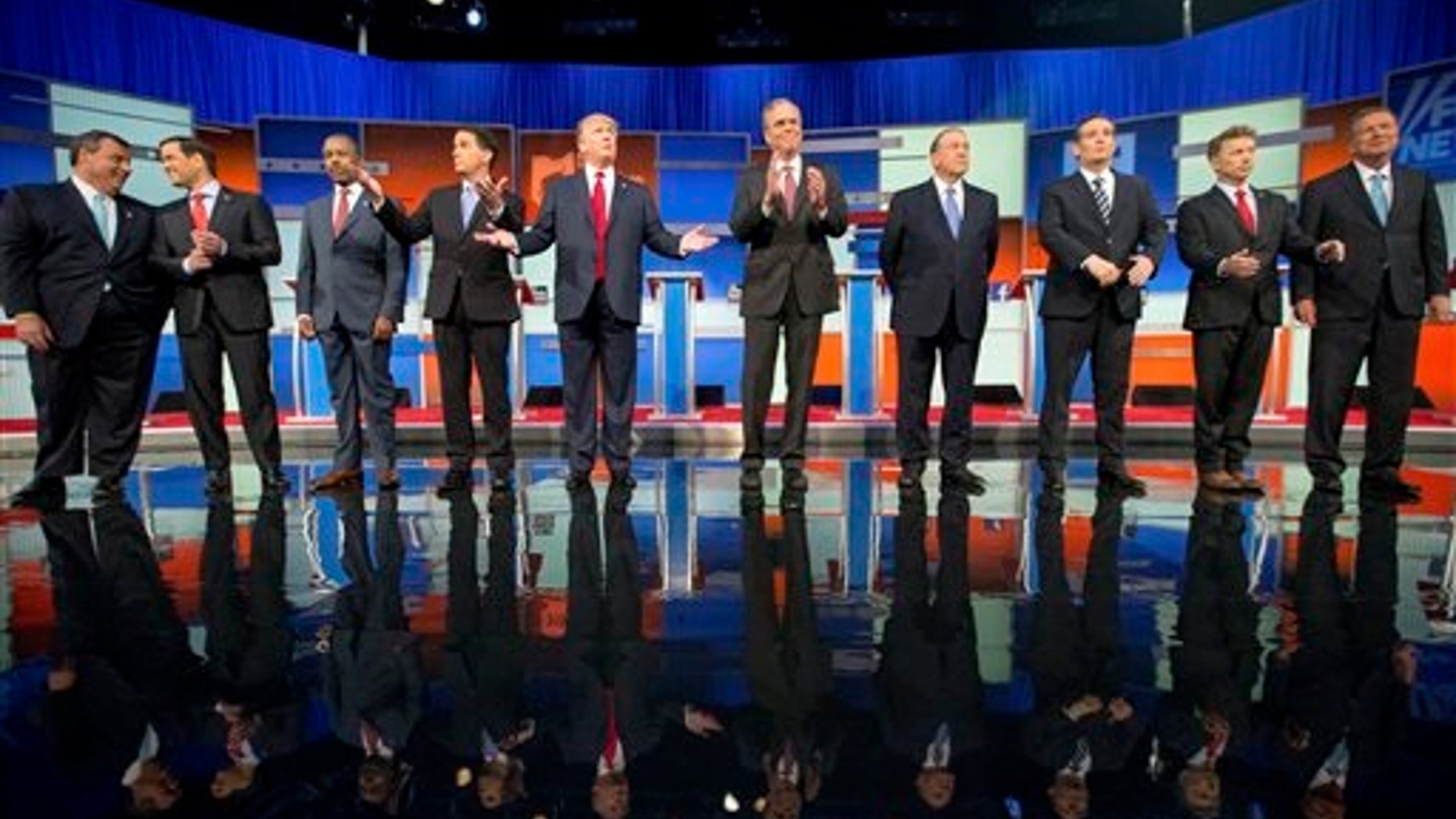Republican presidential candidates from left, Chris Christie, Marco Rubio, Ben Carson, Scott Walker, Donald Trump, Jeb Bush, Mike Huckabee, Ted Cruz, Rand Paul, and John Kasich take the stage for the first Republican presidential debate at the Quicken Loans Arena, Thursday, Aug. 6, 2015, in Cleveland. (AP Photo/Andrew Harnik)