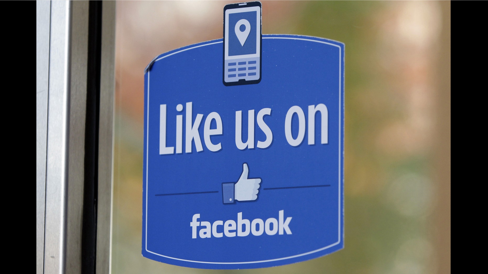 FILE - In this Dec. 13, 2011 file photo, a sign with Facebook's "Like" logo is posted at Facebook headquarters near the office for the company's User Operations Safety Team in Menlo Park, Calif. Celebrities, businesses and even the U.S. State Department have bought bogus Facebook likes, Twitter followers or YouTube viewers from offshore "click farms," where workers tap, tap, tap the thumbs up button, view videos or retweet comments to inflate social media numbers. (AP Photo/Paul Sakuma, File)