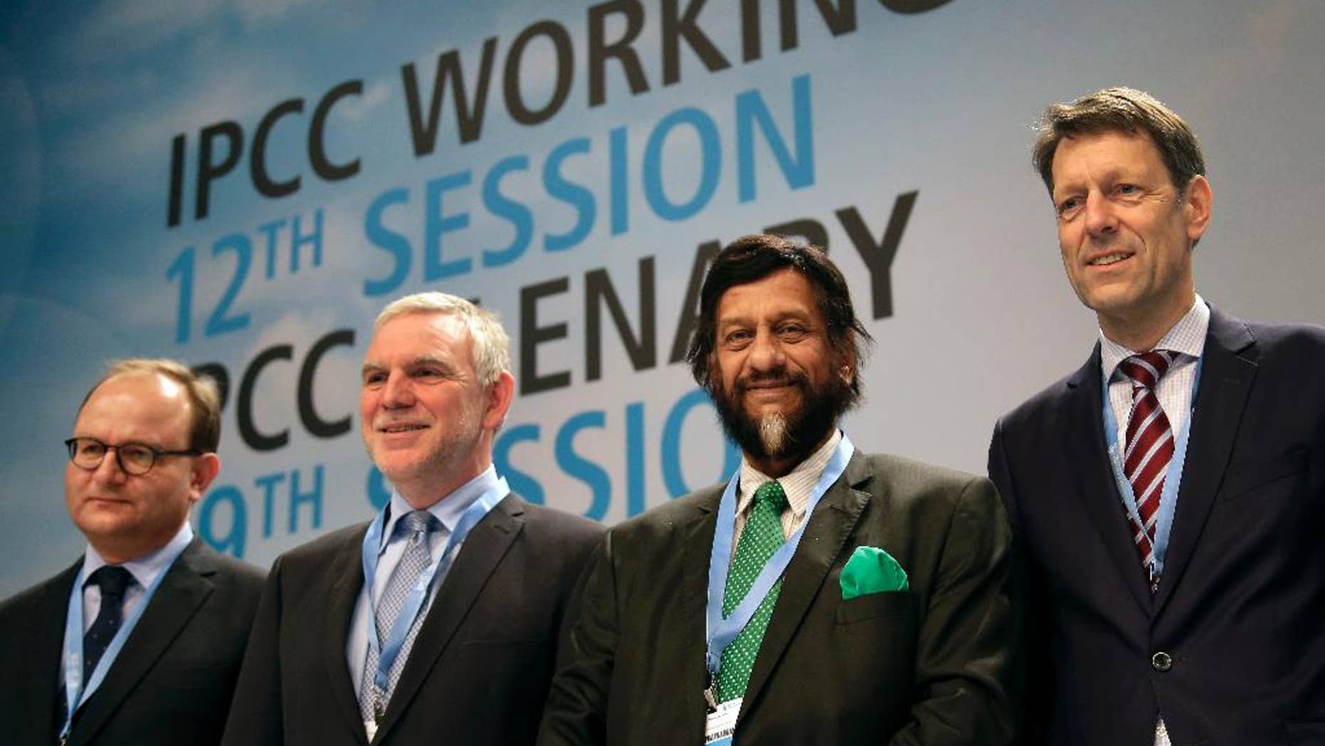 FILE - In this Monday, April 7, 2014 file photo Ottmar Edenhofer, Co-Chairman of the IPCC Working Group III, Jochen Flasbarth, State Secretary of the German Enviroment Ministry, Rejendra K. Pachauri, Chairman of the IPCC, and Jochen Schuette, State Secretary of the German Science Ministry, from left, pose for the media prior to a meeting of the Intergovernmental Panel on Climate Change, IPCC, in Berlin, Germany. After racing against the clock in an all-night session, the U.N.'s expert panel on climate change was putting the final touches Saturday, April 12, 2014, on a scientific guide to help governments, industries and regular people take action to stop global warming from reaching dangerous levels. (AP Photo/Michael Sohn, File)