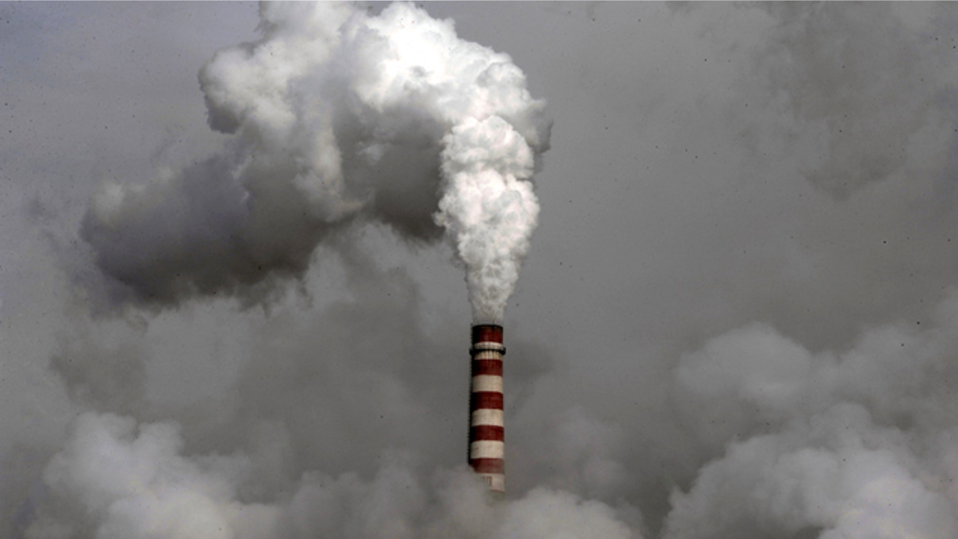 Smoke billows from the chimney of the cooling towers of a coal-fired power plant in Dadong, Shanxi province, China. Two weeks of United Nations climate talks in Bonn came up with a sketchy new draft for a deal to halt global warming, but some nations immediately raised concerns and observers said Friday, June 11, 2010, there is little substantial progress.