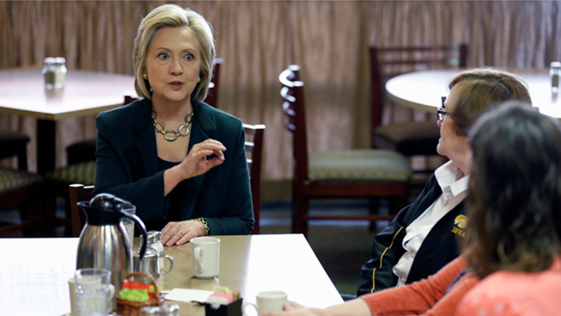 Democratic presidential candidate Hillary Rodham Clinton, left, visits with local residents at The Tremont, Wednesday, April 15, 2015, in Marshalltown, Iowa. (AP Photo/Charlie Neibergall)