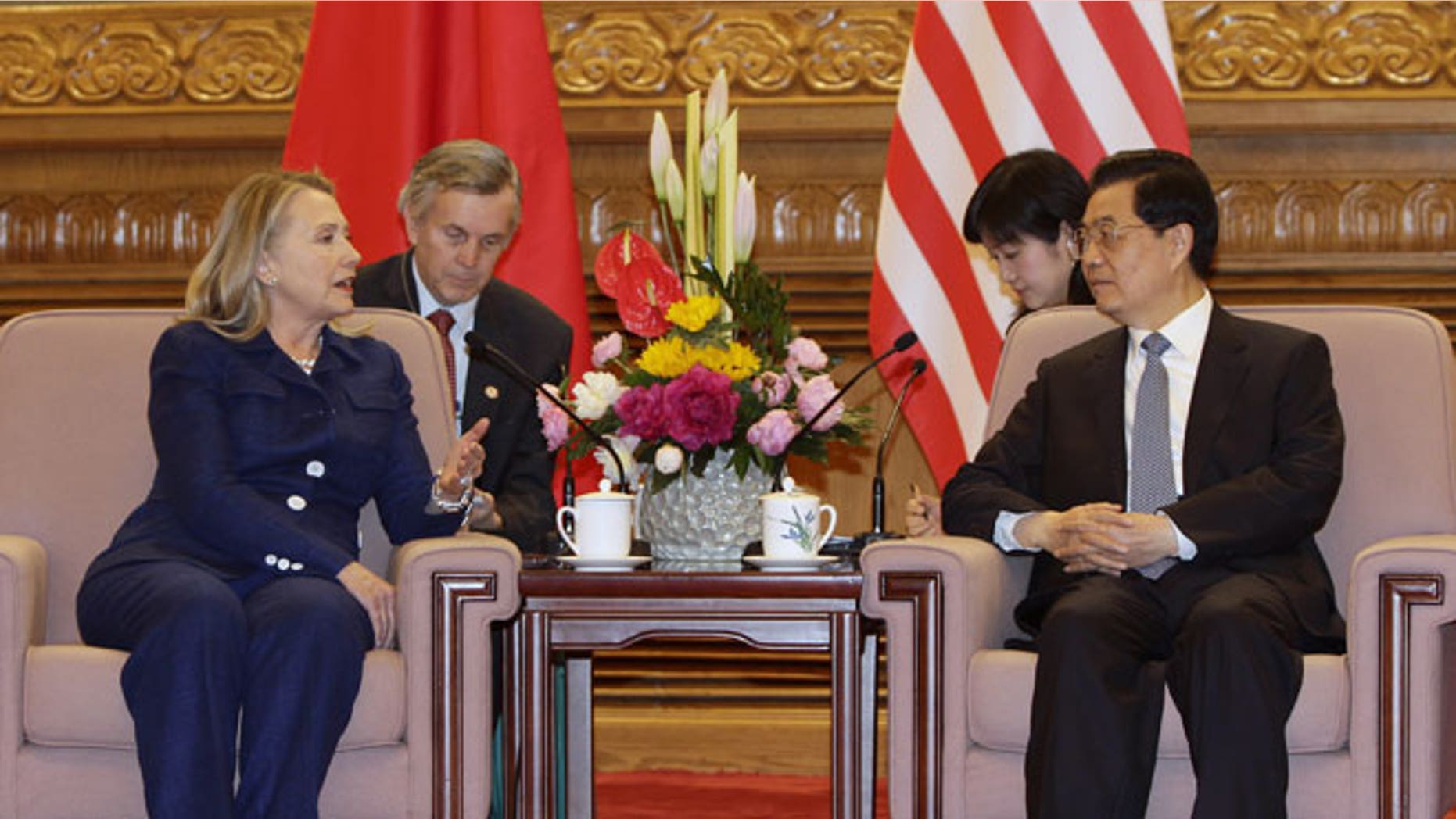 May 4, 2012: U.S. Secretary of State Hillary Rodham Clinton, left, talks to Chinese President Hu Jintao, right, during a meeting at the Great Hall of the People in Beijing.