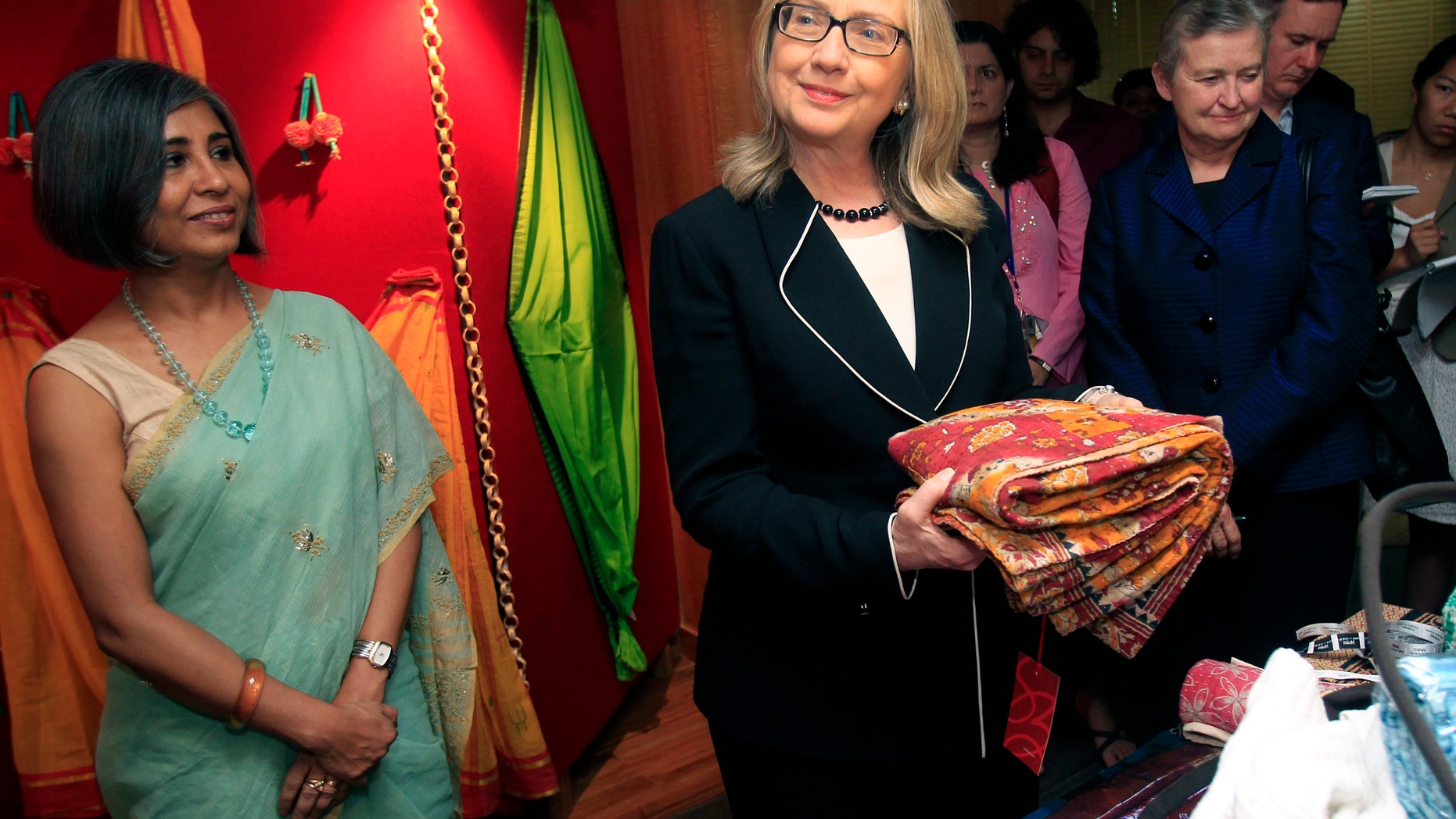 May 6, 2012: U.S. Secretary of State Hillary Clinton holds a sari during an Anti-Human Trafficking event in Kolkata, India.