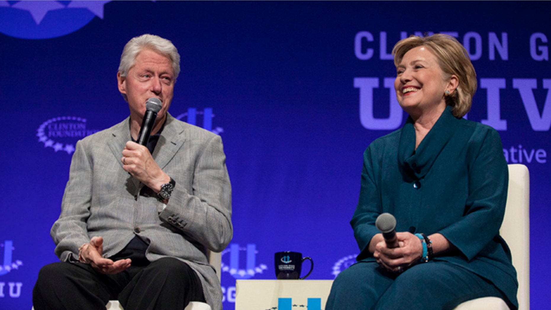 FILE: Former President Clinton and former Secretary of State Hillary Clinton at the 2014 Clinton Global Initiative at Arizona State University, Tempe, Ariz.