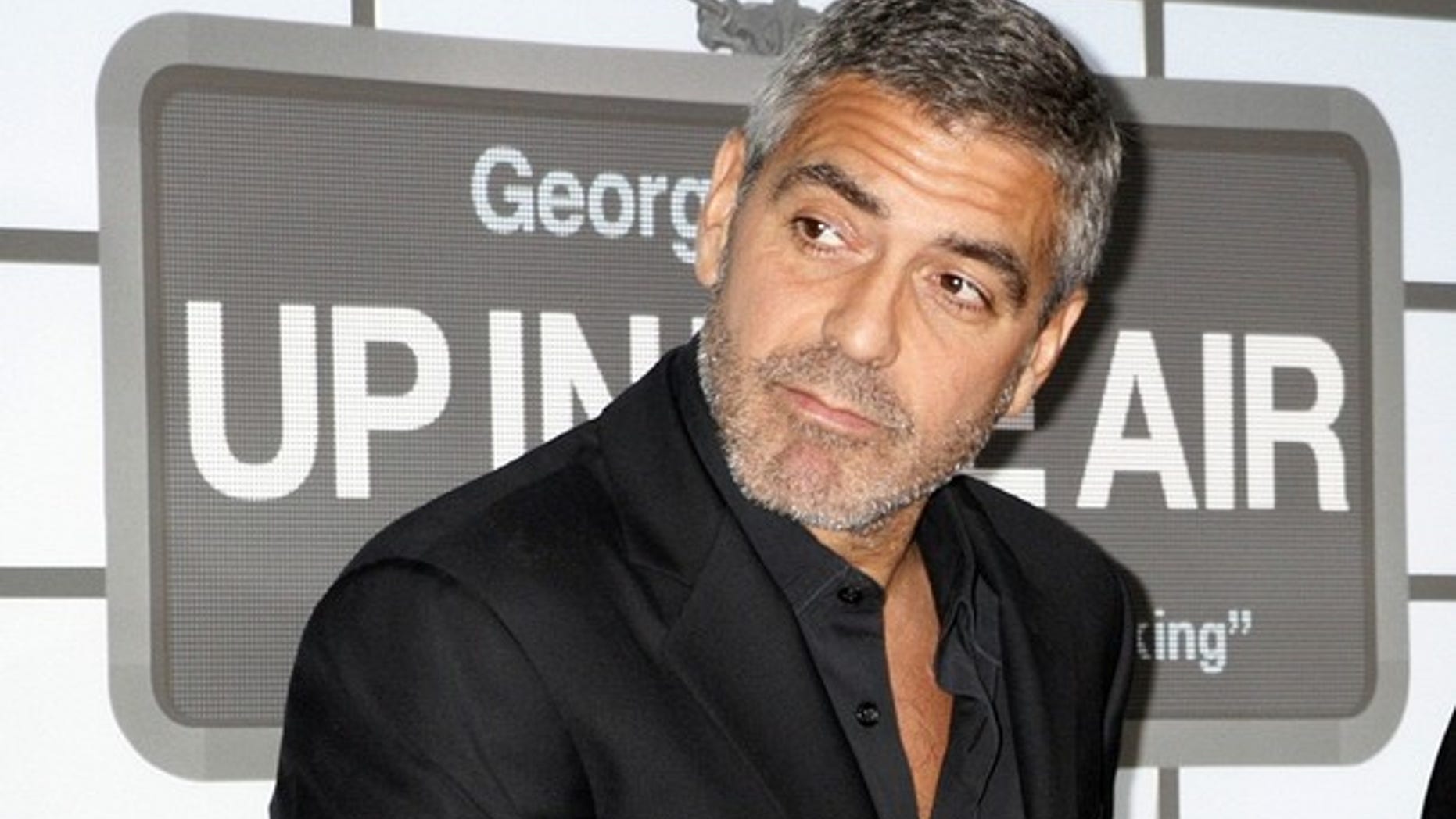Actor George Clooney, star of the film "Up in the Air" poses on the red carpet at the film's premiere in Los Angeles (REUTERS)