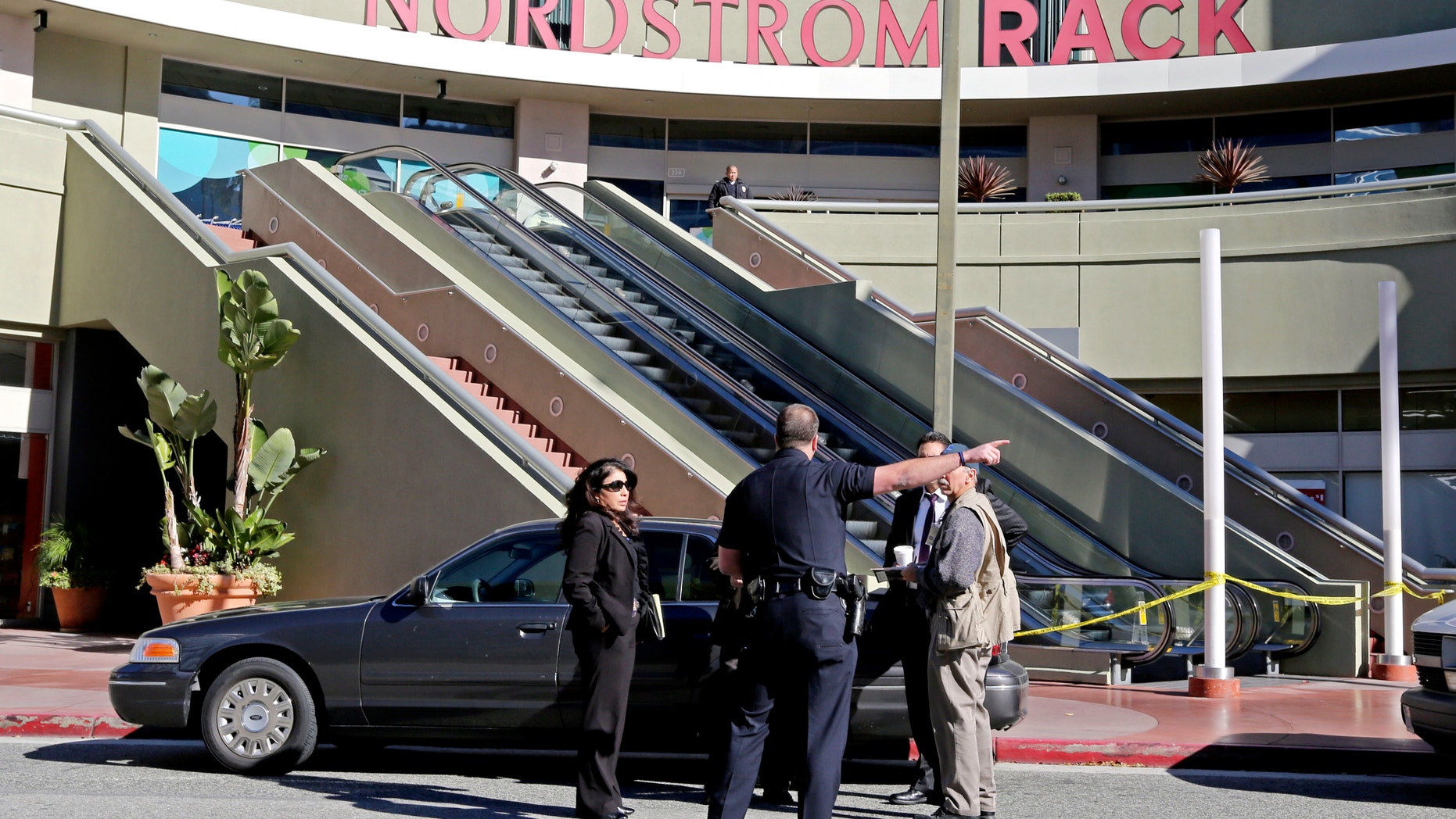 Jan. 11, 2013: Los Angeles police investigators stand outside a Nordstrom Rack store at Howard Hughes Center near Los Angeles International Airport.