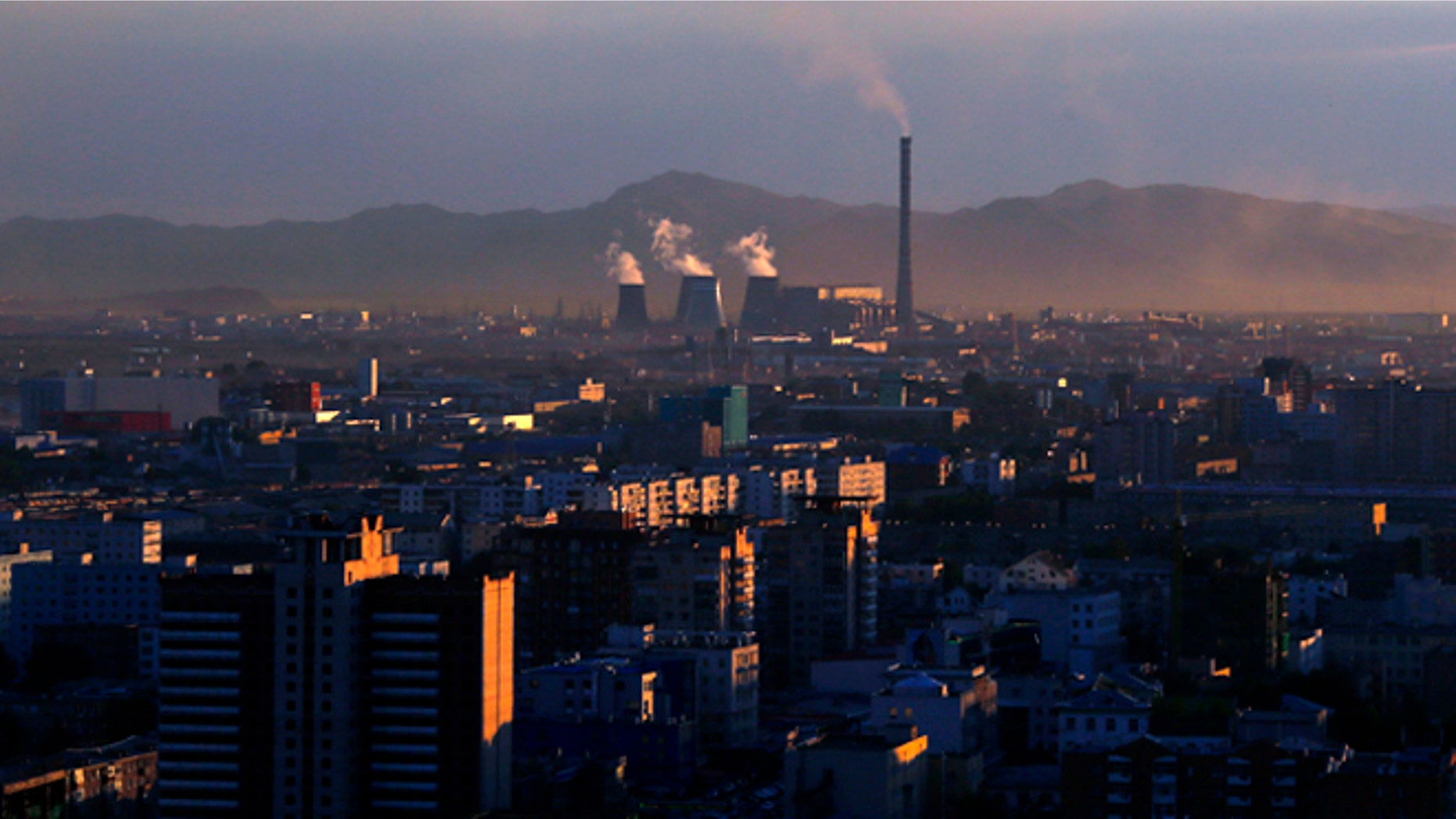Smoke billows from the chimneys of a coal-burning power plant in Ulan Bator, Mongolia.