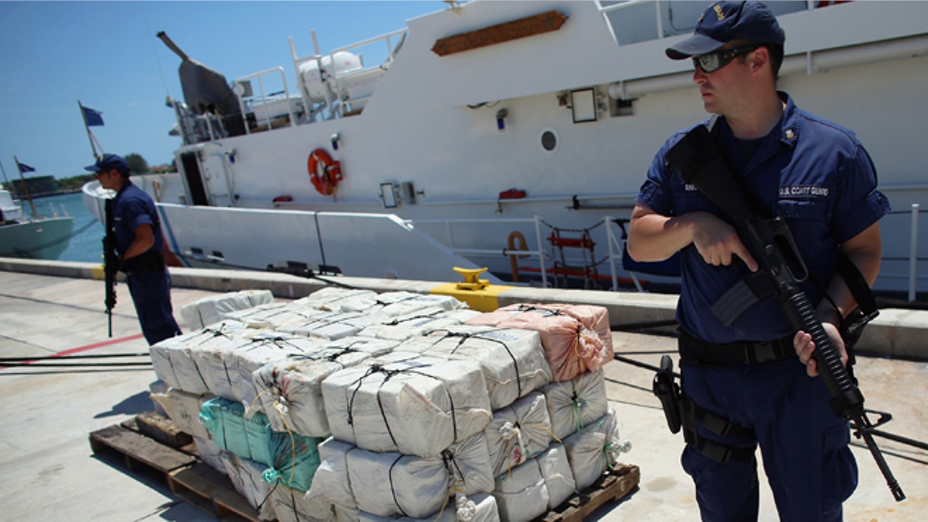 Under heavy security a pile of packages filled with cocaine is piled up after being off loaded from the Coast Guard Cutter Bernard C. Webber after it was seized during Operation Martillo, worth an estimated $27 million on April 26, 2013 in Miami, Florida. (Photo by Joe Raedle/Getty Images)