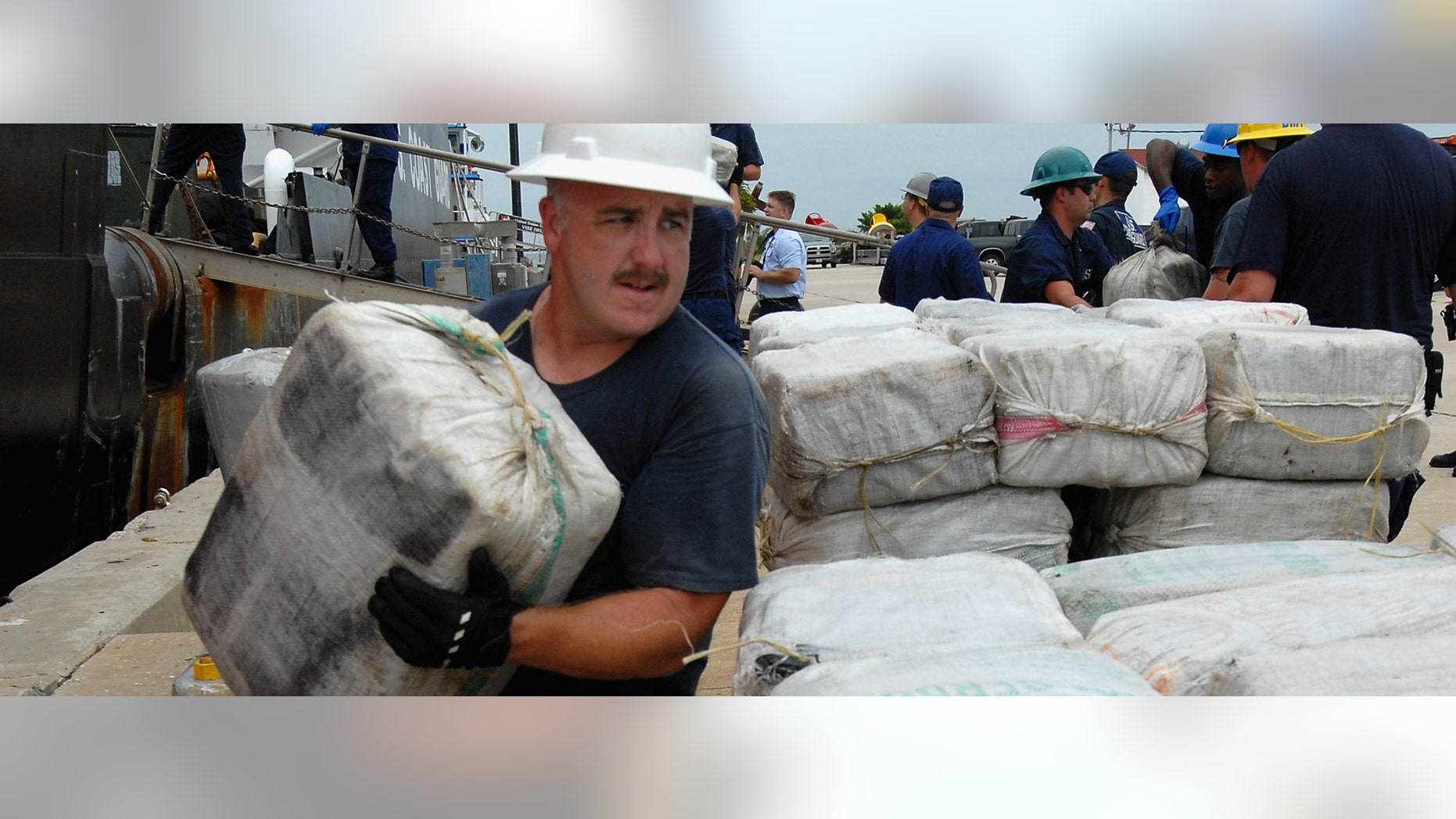 ST PETERSBURG, FL - OCTOBER 28: U.S. Coast Guard members of the U.S.S. Cypress unload seven tons of cocaine seized from a semi-submersible submarine in the Western Caribbean on October 28, 2011 in St Petersburg, Florida. The seizure was made on September 30, 2011 and has a street value of $18 million dollars. (Photo by Tim Boyles/Getty Images)