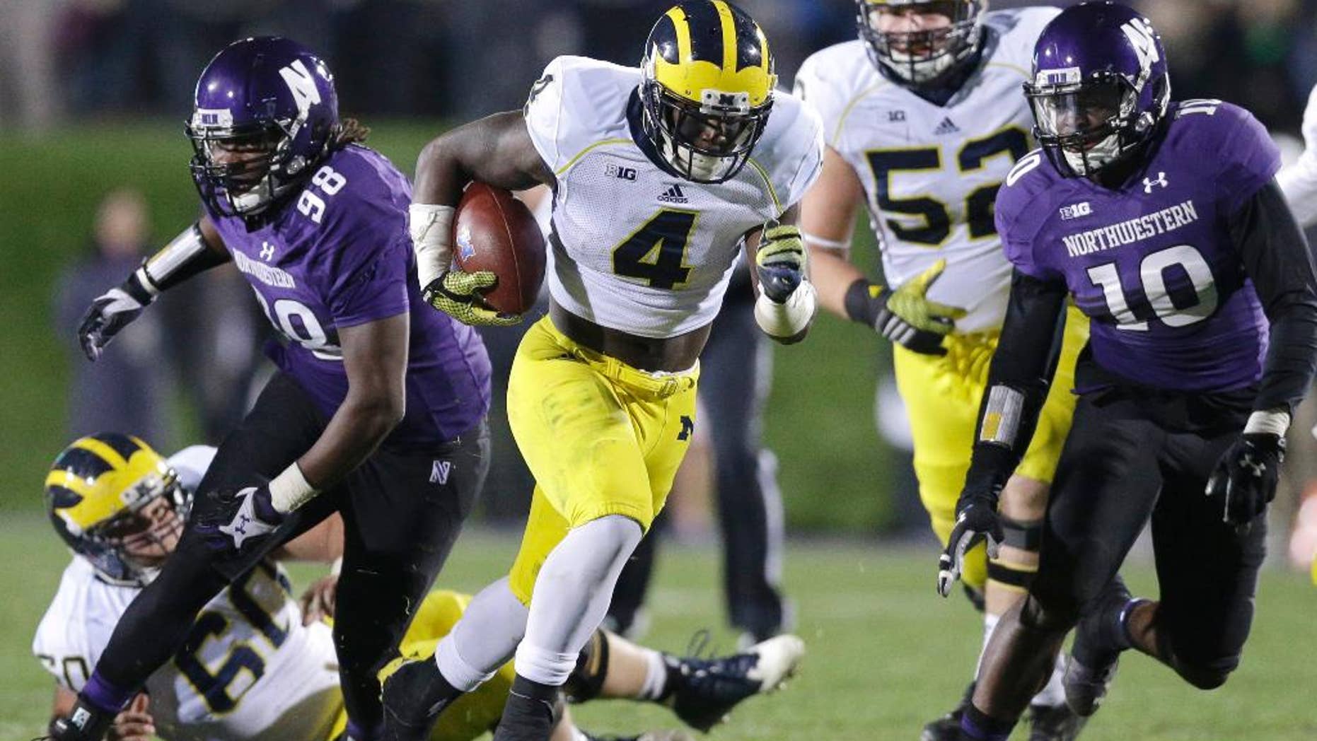 In this Nov. 8, 2014 file photo Michigan running back De'Veon Smith (4) runs against Northwestern during an NCAA college football game in Evanston, Ill. A Republican lawmaker in Michigan introduced a bill Dec. 2, 2014 to block collective bargaining for athletes that is on the fast track through this lame-duck legislative session, though there are no reports of such efforts at any of Michigan's public or private universities and opponents say it's a non-issue in their state. Athletes at Northwestern, a private school, voted in April to form the nation's first union for student athletes, a case the National Labor Relations Board has not yet ruled on. (AP Photo/Nam Y. Huh, File)