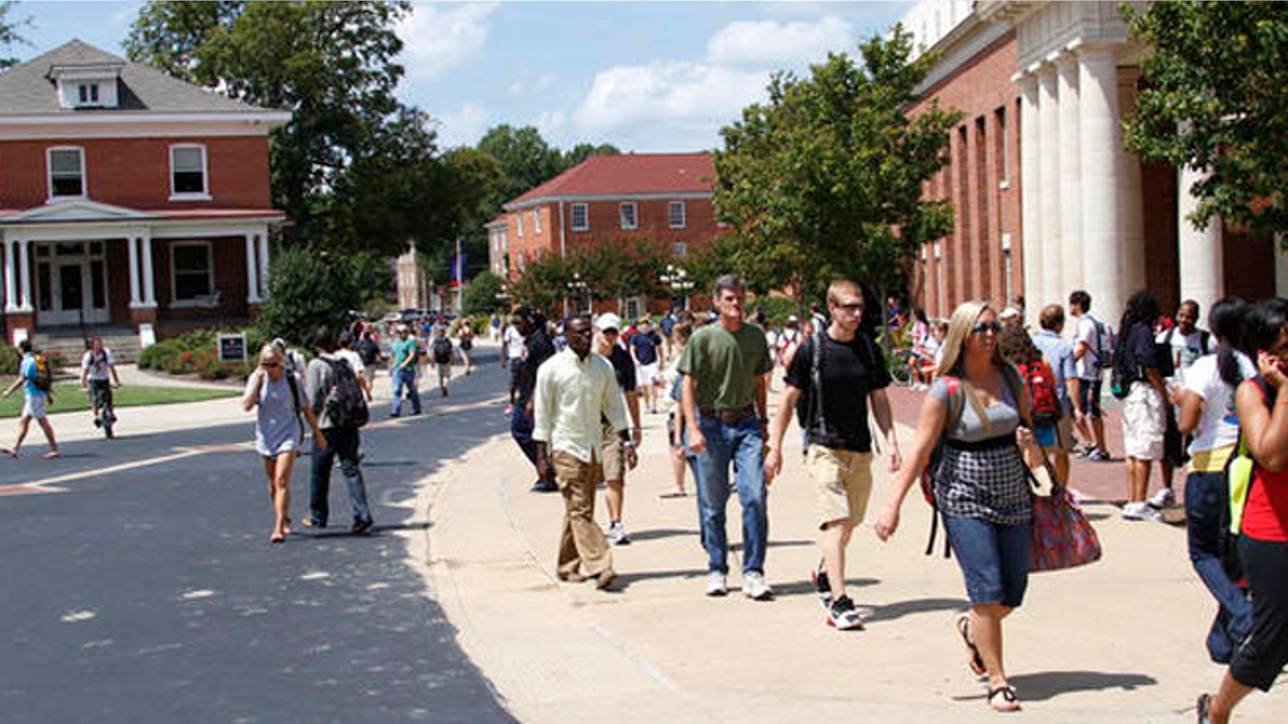 Students rush to class at the University of Mississippi, Sept. 1, 2010, in Oxford, Miss. Fiscal cuts from state funding are expected to affect all of the state's eight public colleges and may force faculty and staff layoffs, program eliminations and cuts in classes and services offered to students as well as raise various fees at the schools while they try to lessen the loss of funds. (AP Photo/Rogelio V. Solis)