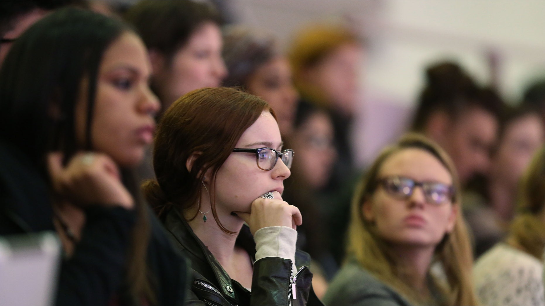 NEW YORK, NY - OCTOBER 19: Students watch as the Dalai Lama stands on stage at Hunter College where he received an honorary degree, a Doctor of Humane Letters, on October 19, 2012 in New York City. The Dalai Lama, the spiritual leader of Tibetan Buddhists and a Nobel Peace Prize winner, will also give a talk on the "Essence of Buddhism," October 21 at Lincoln Center. (Photo by Spencer Platt/Getty Images)