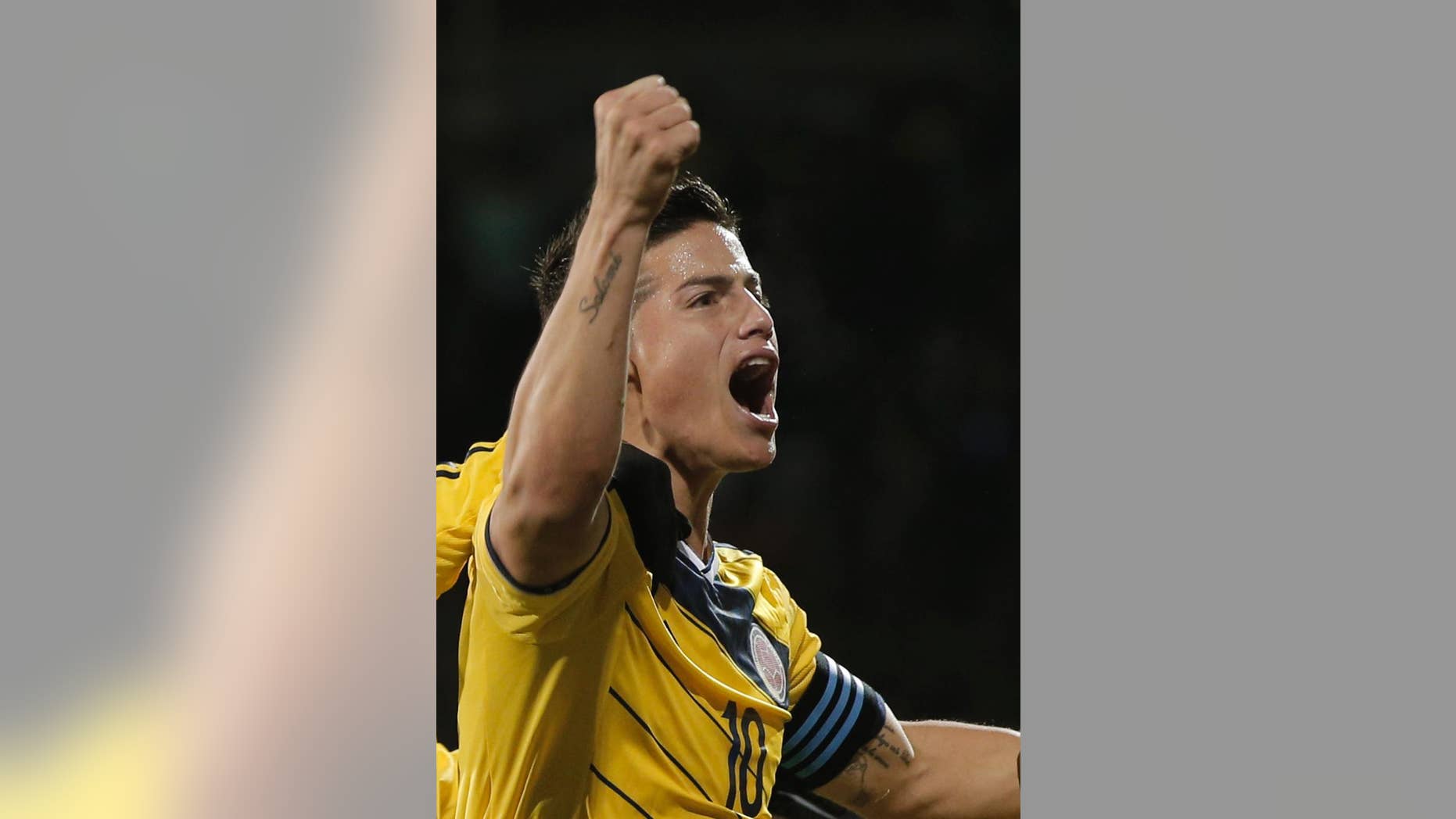 FILE - In this Nov. 14, 2014, file photo, Colombia's captain James Rodriguez celebrates after his teammate Carlos Bacca, scored against USA, during an international friendly soccer match at the Craven Cottage ground in London. The U.S. has imposed sanctions on Rodriguez's first professional team, the Envigado soccer club, for alleged ties to a drug cartel. The Treasury Department on Wednesday Nov. 19, 2014, placed the club and its owner, Juan Pablo Upequi, on its foreign narcotics kingpins list, freezing any U.S. assets they may have and barring Americans from doing business with them. (AP Photo/Lefteris Pitarakis, File)