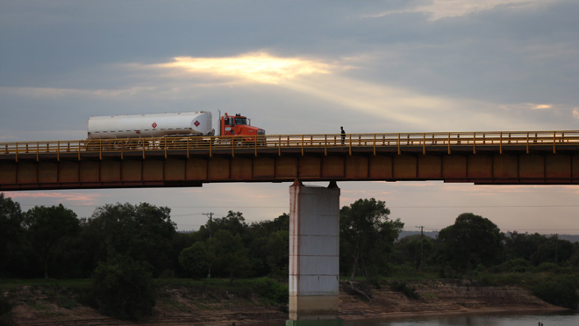 In this Feb. 13, 2015 photo, a truck loaded with crude from the Campo Rubiales oil field crosses the bridge over the Manacacias River in Puerto Gaitan, Colombia. A net oil importer not too long ago, Colombia is now the fifth biggest supplier to the U.S. (AP Photo/Fernando Vergara)
