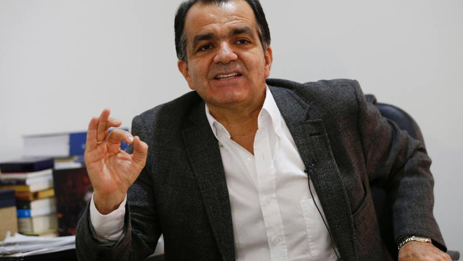 Oscar Ivan Zuluaga, presidential candidate for the Democratic Center speaks during an interview with Associated Press in Bogota, Colombia, Tuesday, June 3, 2014. Zualuaga will face President Juan Manuel Santos, who is seeking a second four-year term as candidate of the Social Party of National Unity, in a presidential runoff on June 15. (AP Photo/Fernando Vergara)