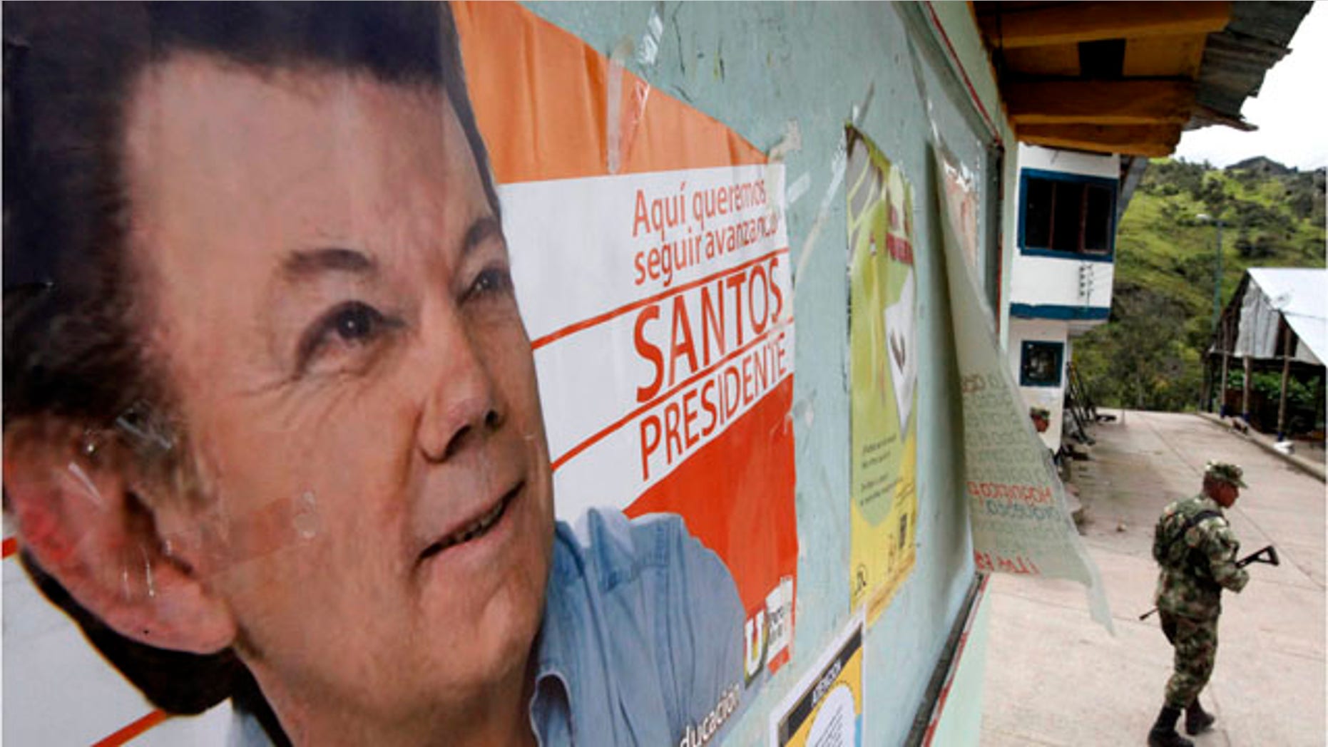 May 26: A soldier patrols under a poster of Juan Manuel Santos, the presidential candidate of the Social National Unity Party, in Nazareth, south of Bogota, The government has tightened the security ahead of May 30 presidential election.
