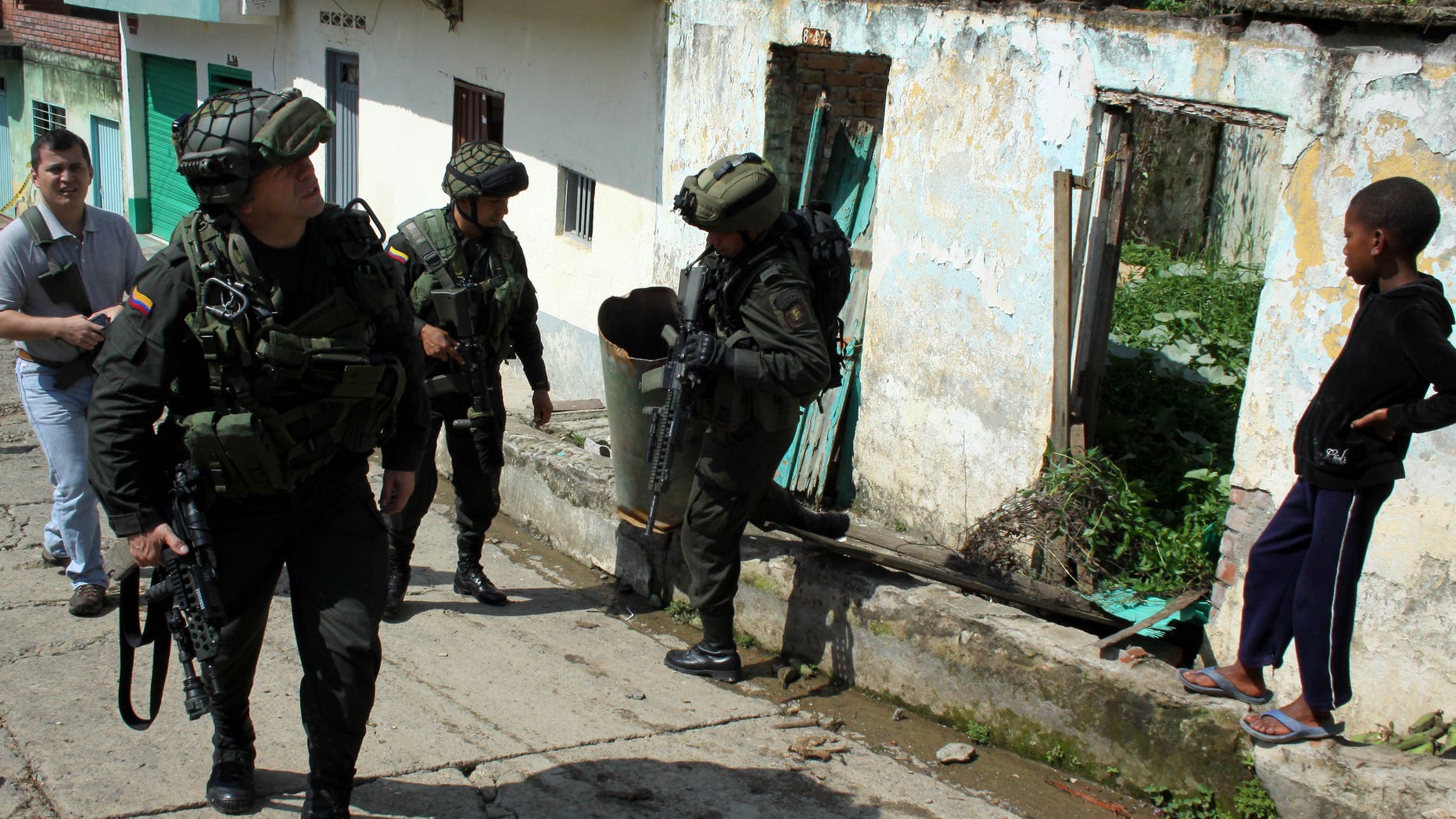 Nov. 12, 2012: Police officers inspect a house that was damaged by home made grenades thrown by alleged rebels of the Revolutionary Armed Forces of Colombia, or FARC, near a police station in Suarez, in Colombia's southern state of Cauca.
