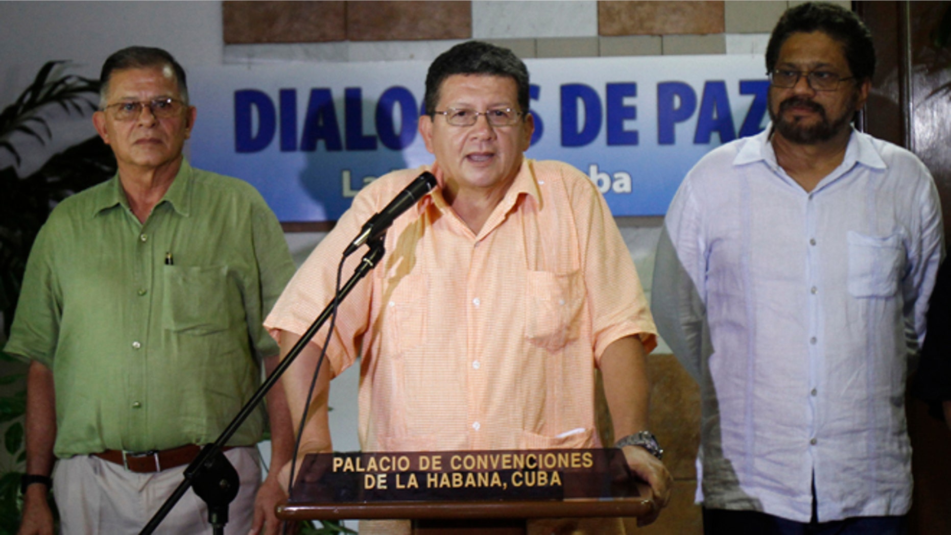 Pablo Catatumbo, chief of the western bloc of the Revolutionary Armed Forces of Colombia, or FARC, center, speaks to journalists accompanied by Ricardo Tellez, left, and Ivan Marquez, chief FARC negotiator during peace talks with Colombia's government in Havana, Cuba, Friday, Aug. 23, 2013. Colombia's largest guerrilla army temporarily walked away from peace talks with the government Friday over President Juan Manuel Santos' refusal to agree to modify the constitution if a peace pact is struck. (AP Photo/Ismael Francisco, Cubadebate)
