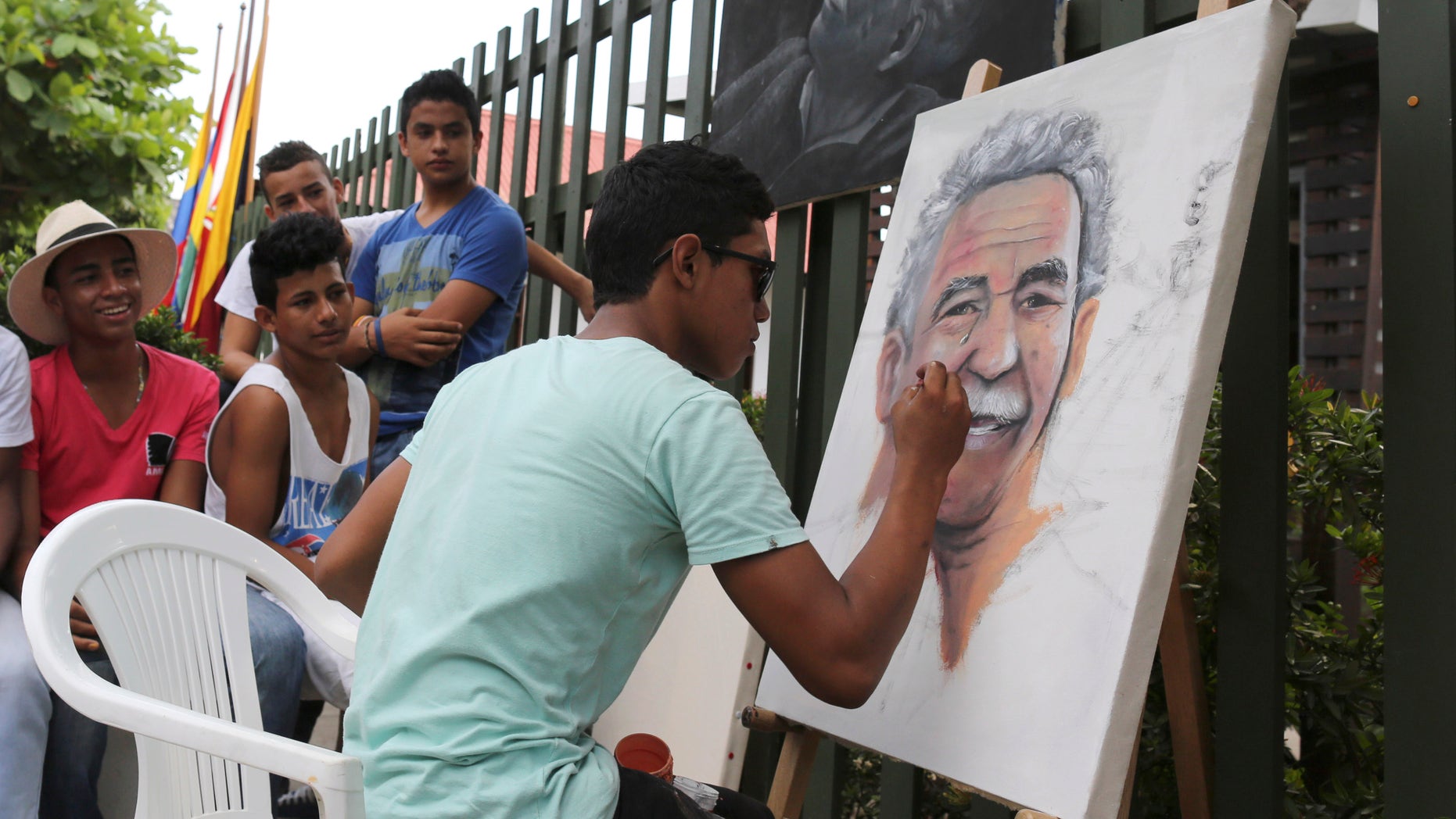 Melquin Merchan paints a portrait of 'Gabo' in front of the house where he was born in Aracataca, Colombia.