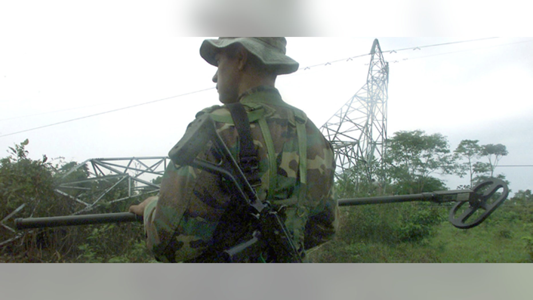 403962 01: A Colombian soldier searches for possible land mines left by the FARC, The Revolutionary Armed Forces of Colombia, after the group dynamited an energy tower owned by the state operated national energy distribution network, ISA, April 15, 2002 in Saravena, Colombia. The companys energy towers have been attacked repeatedly this year by the guerrilla group in a war against state-owned infrastructure leaving entire states without energy, sometimes for weeks. (Photo by Carlos Villalon/Getty Images)