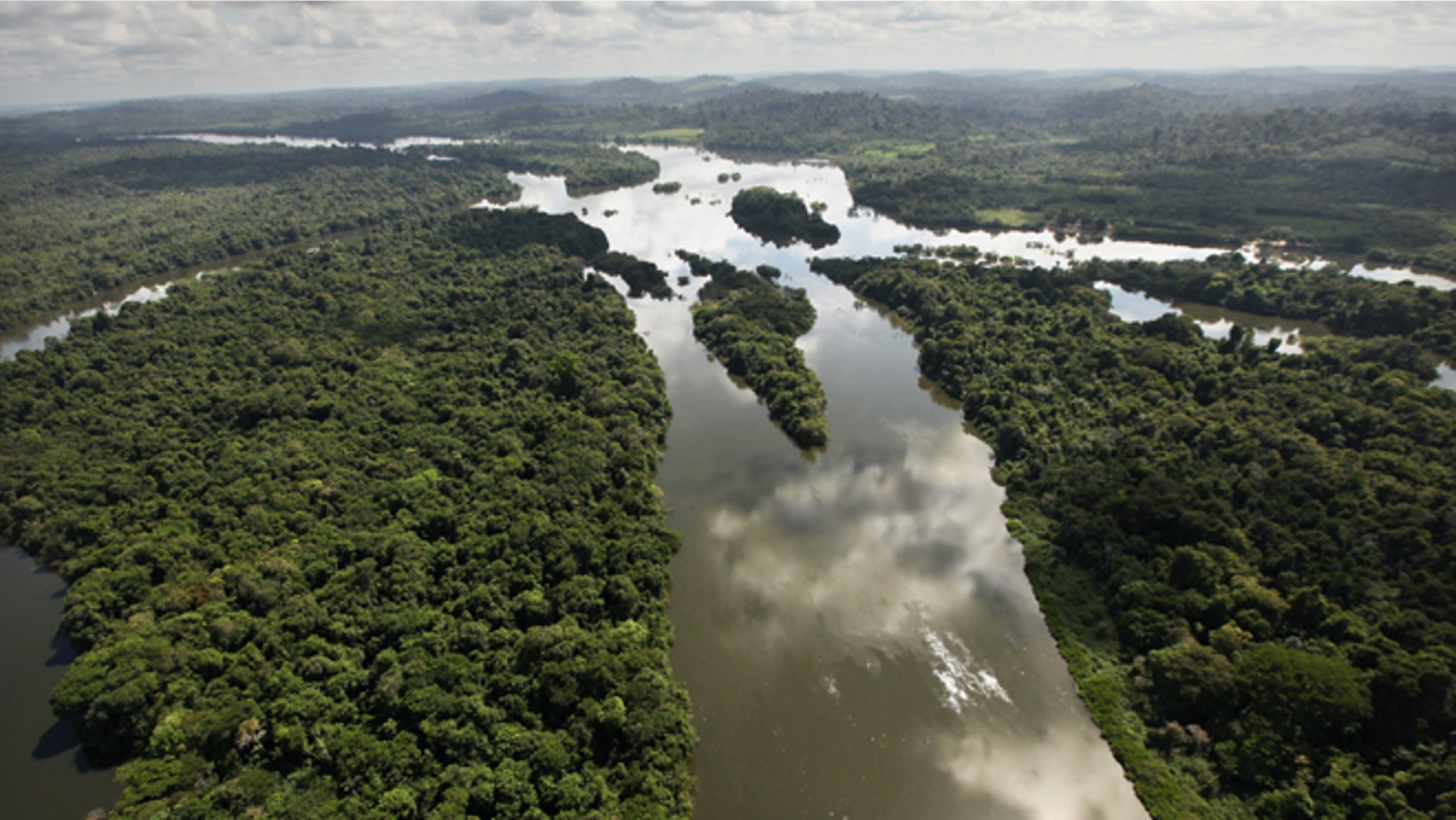 NEAR ALTAMIRA, BRAZIL - JUNE 15: The Xingu River flows near the area where the Belo Monte dam complex is under construction in the Amazon basin on June 15, 2012 near Altamira, Brazil. Belo Monte will be the worldâs third-largest hydroelectric project and will displace up to 20,000 people while diverting the Xingu River and flooding as much as 230 square miles of rainforest. The controversial project is one of around 60 hydroelectric projects Brazil has planned in the Amazon to generate electricity for its rapidly expanding economy. While environmentalists and indigenous groups oppose the dam, many Brazilians support the project. The Brazilian Amazon, home to 60 percent of the worldâs largest forest and 20 percent of the Earthâs oxygen, remains threatened by the rapid development of the country. The area is currently populated by over 20 million people and is challenged by deforestation, agriculture, mining, a governmental dam building spree, illegal land speculation including the occupation of forest reserves and indigenous land and other issues. Over 100 heads of state and tens of thousands of participants and protesters will descend on Rio de Janeiro, Brazil, later this month for the Rio+20 United Nations Conference on Sustainable Development or âEarth Summitâ. Host Brazil is caught up in its own dilemma between accelerated growth and environmental preservation. (Photo by Mario Tama/Getty Images)
