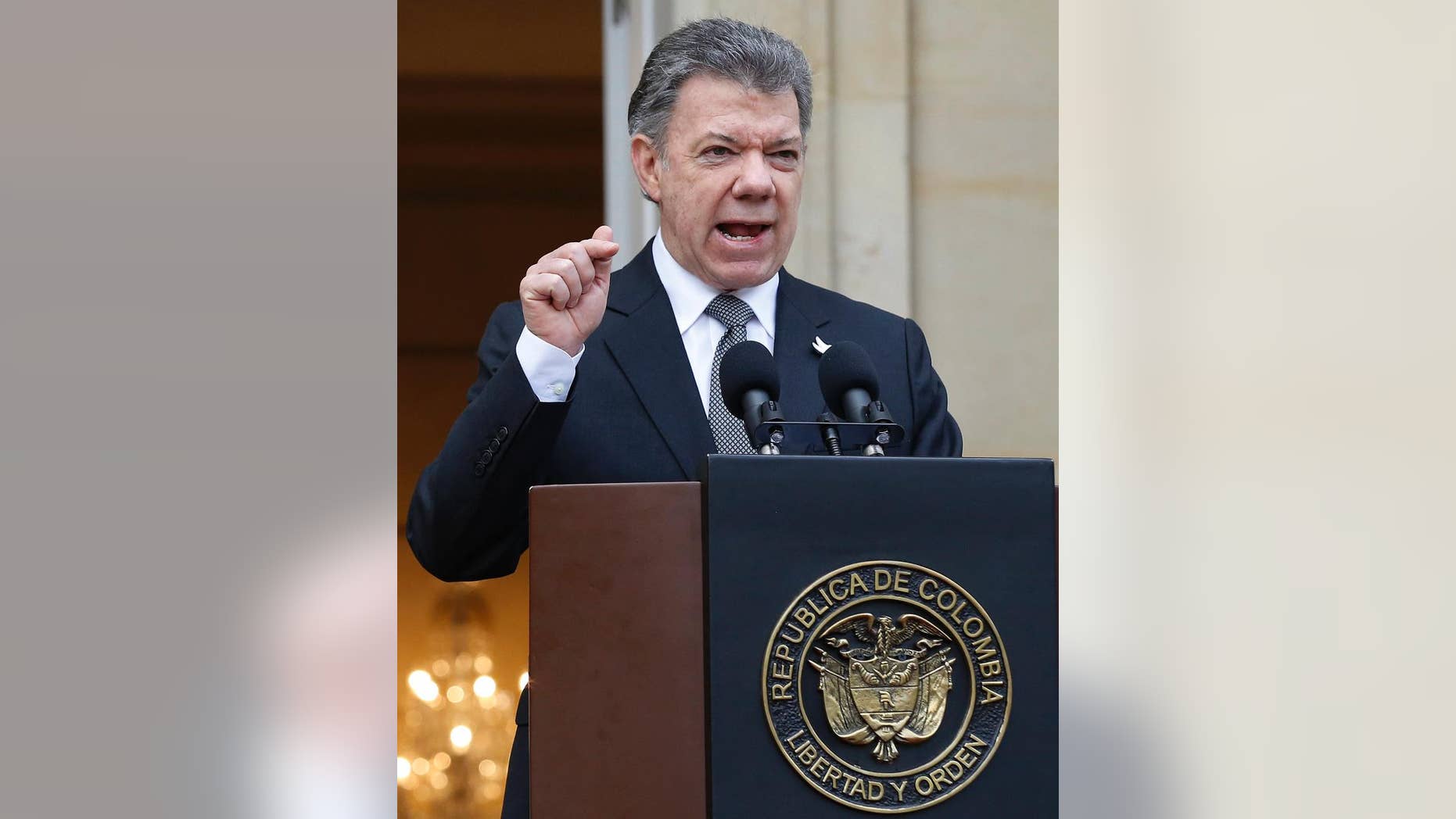 Colombia's President Juan Manuel Santos speaks to the media after a welcoming ceremony for South Korea's President Park Geun-hye at the presidential palace in Bogota, Colombia, Friday, April 17, 2015. In a sharply worded rebuke, Santos said Colombians' patience is wearing thin after guerrillas this week attacked an army platoon sleeping in the field and killed 11 soldiers. (AP Photo/Fernando Vergara)