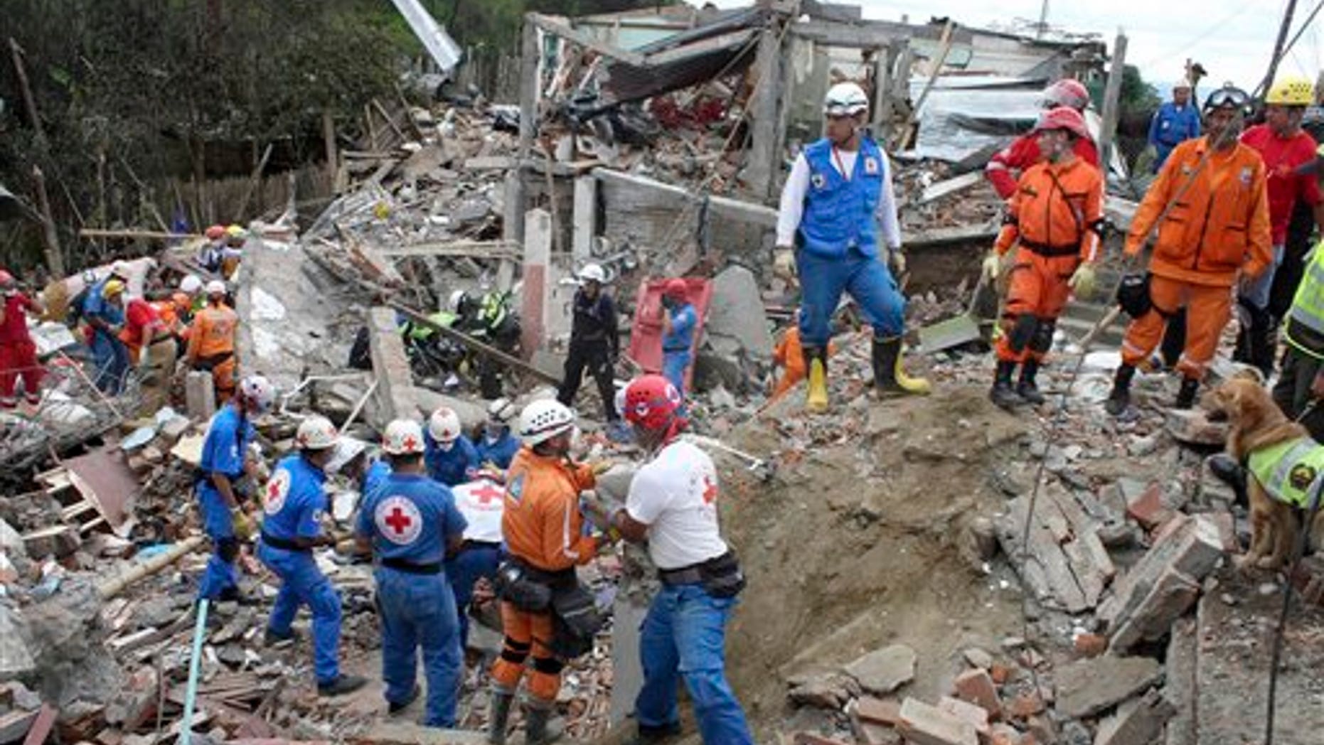 Dec. 23: Rescue workers search for survivors in the rubble of homes destroyed by a pipeline explosion in Dos Quebradas, Colombia.