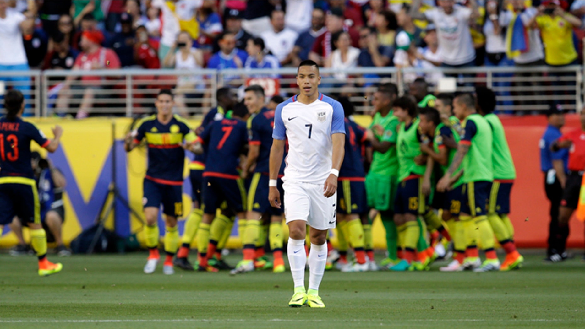 Colombia's players celebrate after scoring their first goal as United States' Bobby Wood, center, walks away during a Copa America Centenario Group A soccer match at the Levi's Stadium in Santa Clara, Calif., Friday, June 3, 2016. Colombia scored 2 first-half goals beating the US in the opener of the Copa America.(AP Photo/Marcio Jose Sanchez)