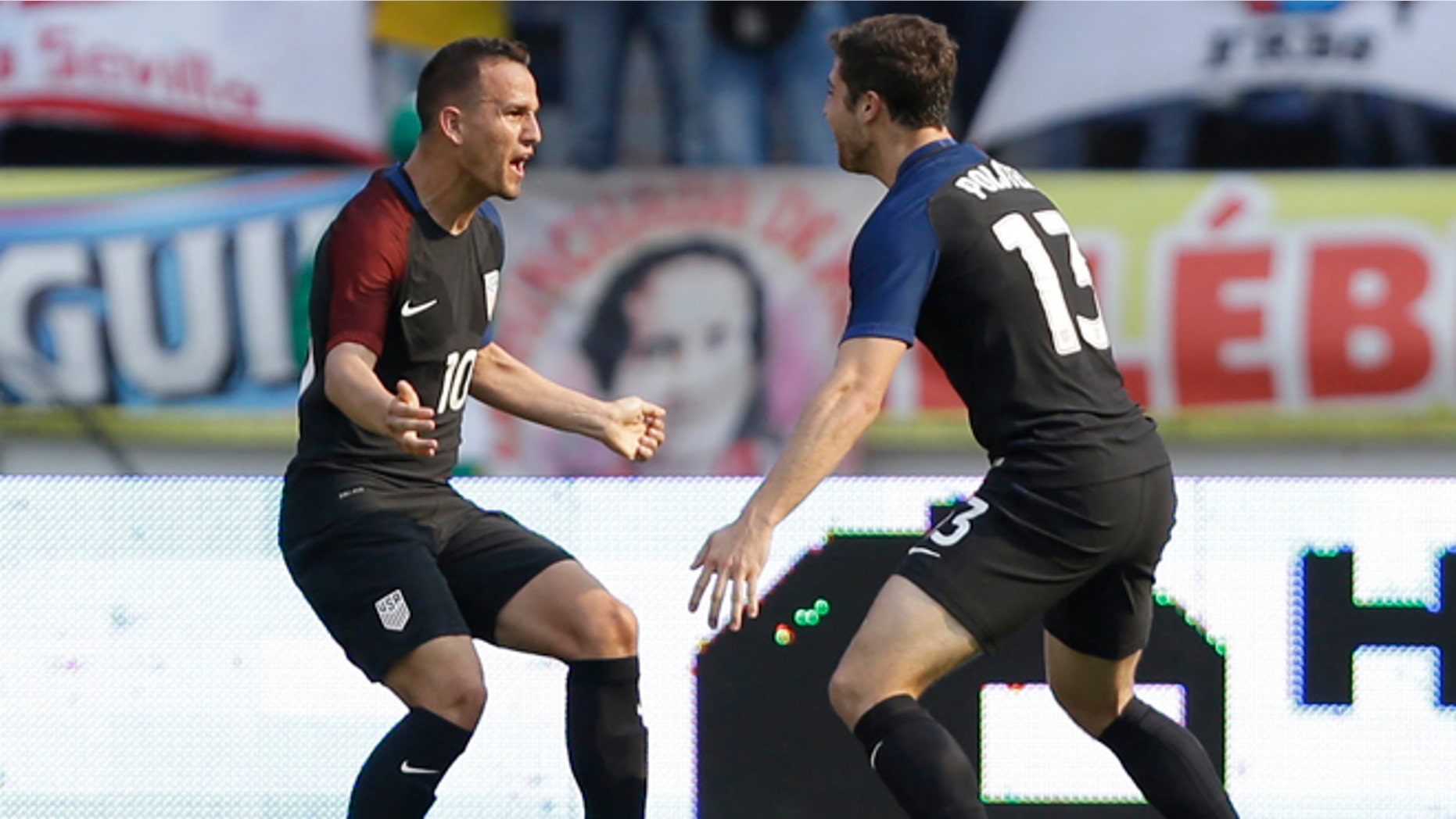 United States' Luis Gil, left, celebrates with teammate Matt Polster after scoring his side's first goal against Colombia during a U-23 first leg soccer match qualifier for the 2016 Rio Olympics at the Roberto Melendez Stadium in Barranquilla, Colombia, Friday, March 25, 2016. (AP Photo/Fernando Vergara)