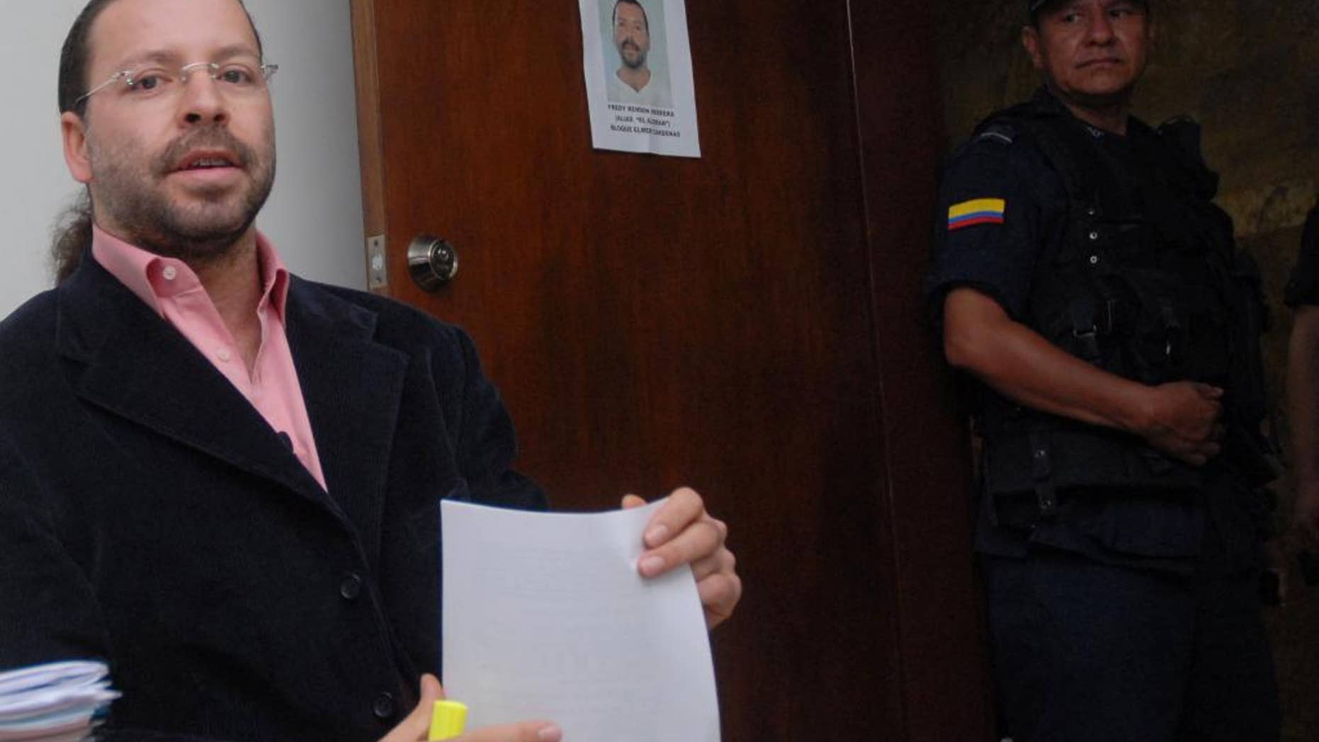 FILE - In this June 5, 2007 file photo, former paramilitary leader Freddy Rendon sits inside a court before a hearing in Medellin, Colombia. Rendon, better known by his alias “the German”, was released from jail Thursday, July 30, 2015. He is the most senior paramilitary commander to be freed after completing the maximum eight years stipulated in a law for former militia members who confess their war crimes to prosecutors and compensate victims. (AP Photo/ Luis Benavides, File)