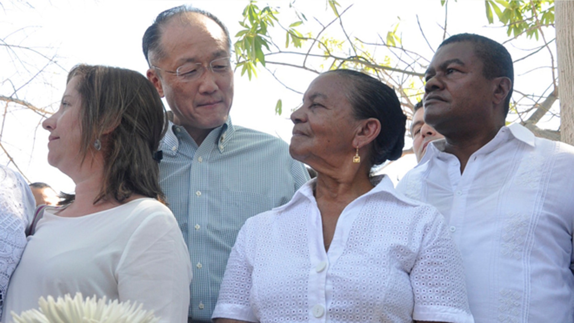 World Bank President Dr. Jim Yong Kim looks at Norma Quiroz, widow of slain community activist Aljemiro Quiroz, in Guacoche, Colombia, Thursday, Jan. 14, 2016.