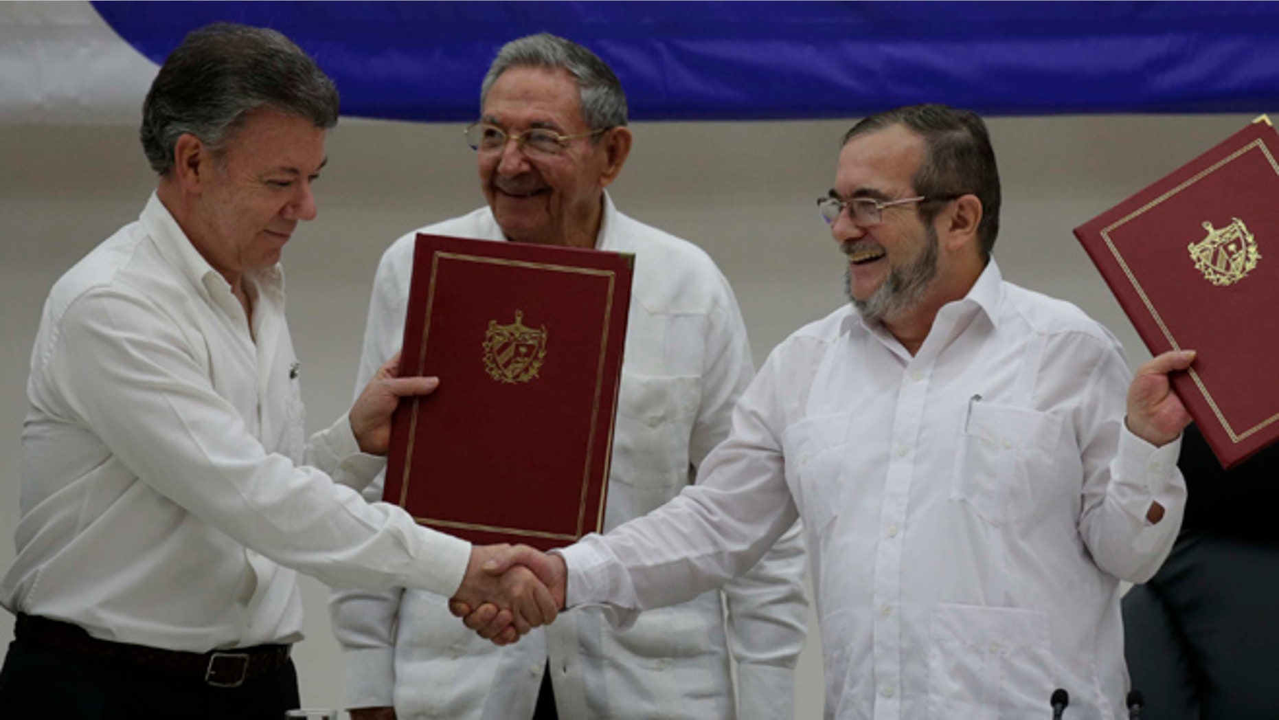 Colombian President Juan Manuel Santos, left, and FARC Commander Timoleon Jimenez on June 23, 2016.