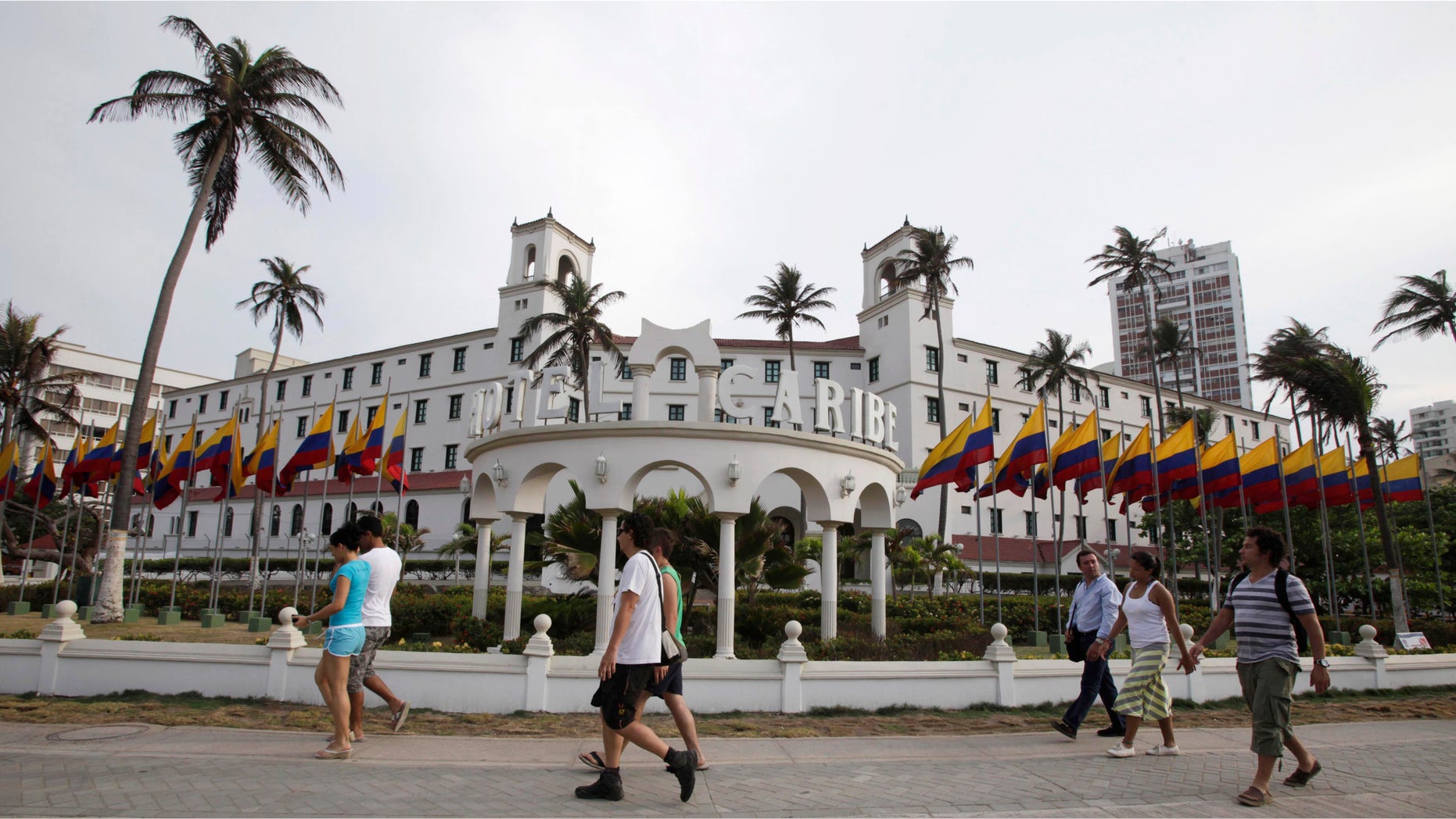People walk past Hotel El Caribe in Cartagena, Colombia, Saturday April 14, 2012. (AP Photo/Fernando Vergara)
